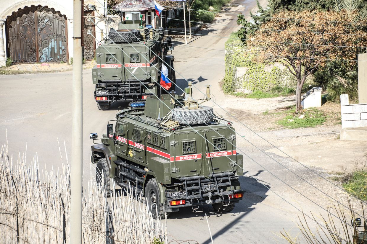 Russian military vehicles, including helicopters, planes, and surveillance balloons, enter Khmeimim Air Base in Jabla, Syria, on Dec. 15, 2024. 