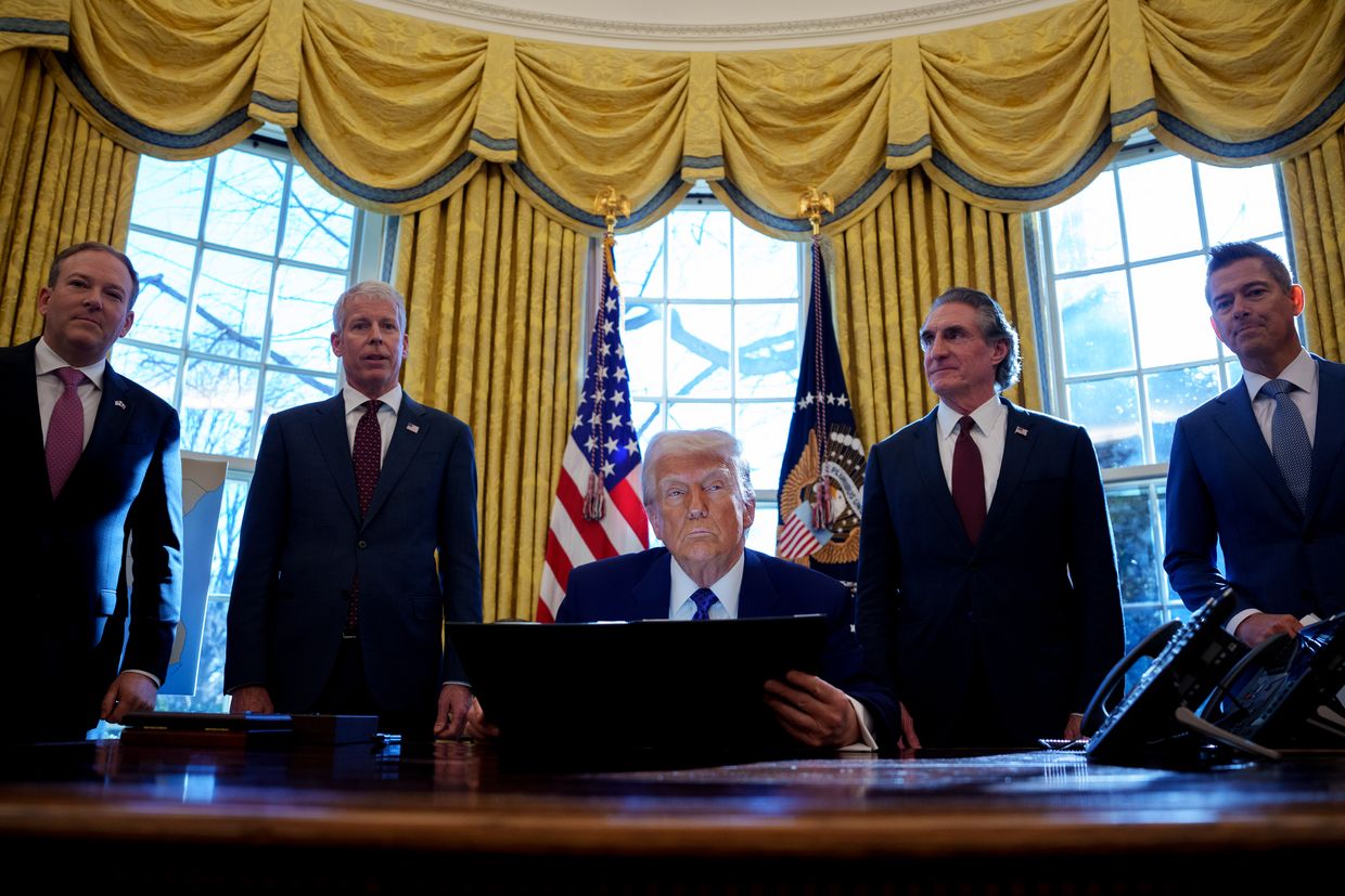 U.S. President Donald Trump (C) in the Oval Office at the White House, in Washington, DC on Feb. 14, 2025. 