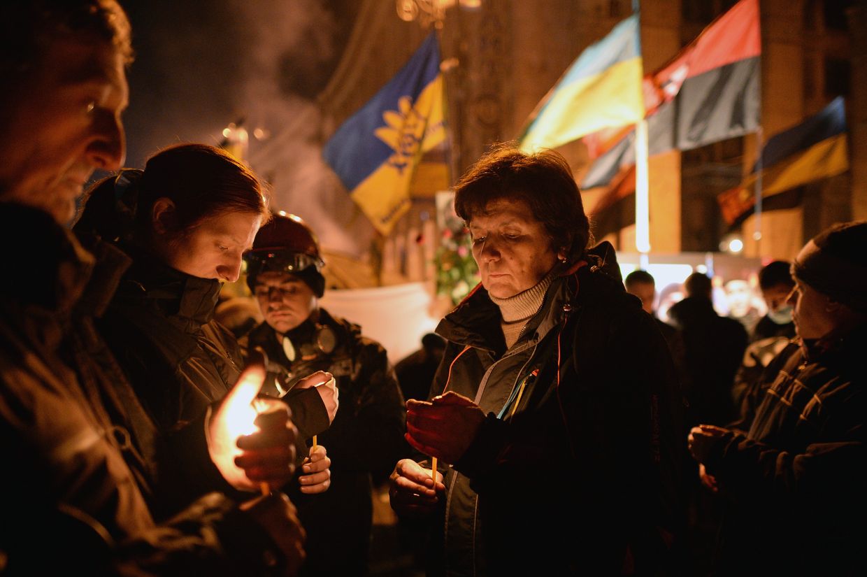 People attend a prayer service for victims killed during clashes between anti-government protesters and police in Independence Square, Kyiv, Ukraine, on Feb. 20, 2014. 