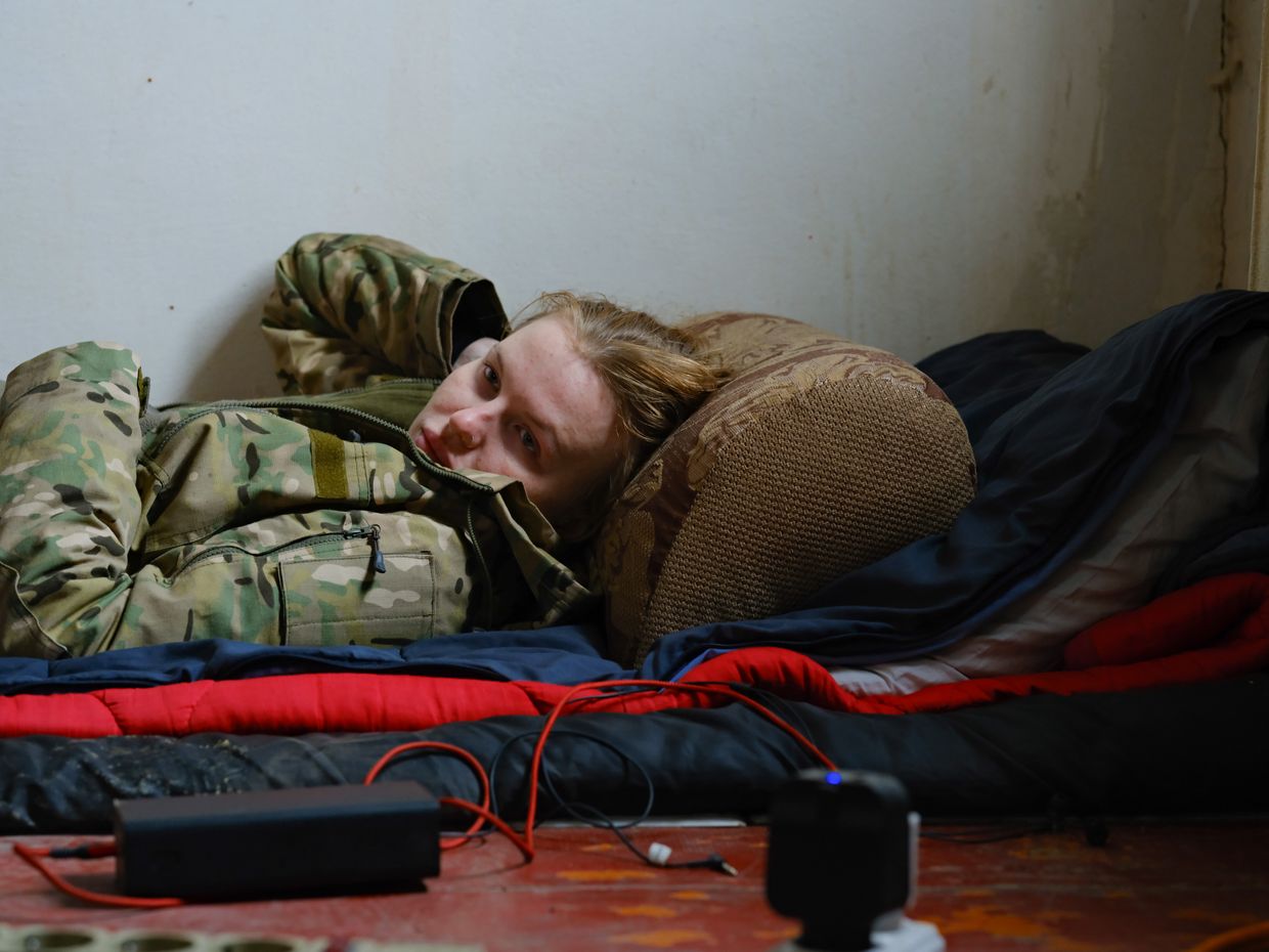 Olesya "Alaska," a combat medic, rests while visiting the place of deployment of her friend Kuba, Kostiantynivka, Donetsk Oblast, Ukraine, in Oct. 2024.