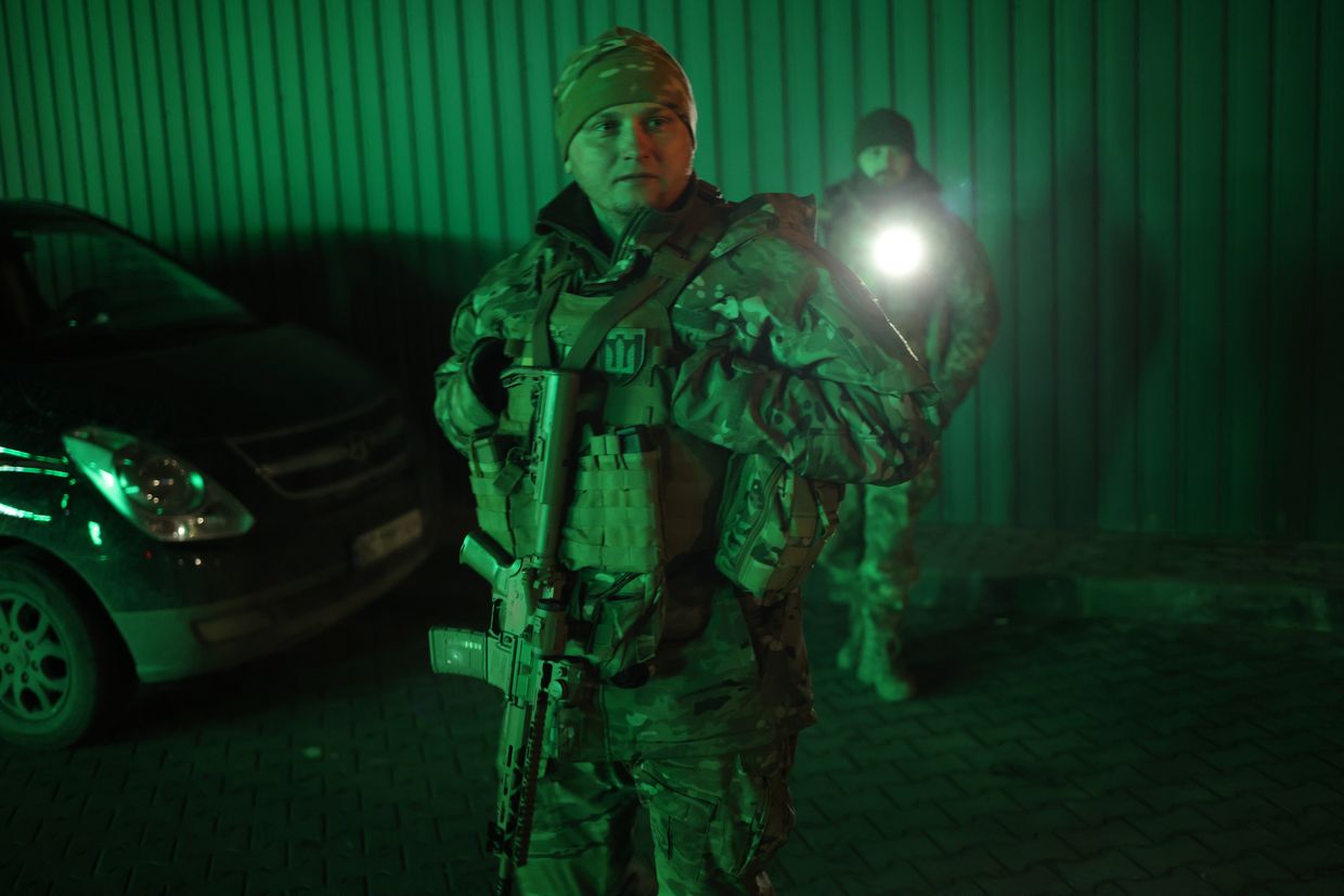 Yaroslav Kryvulya (C) and members of TSEL patrol during curfew in Lviv, Ukraine, on Feb. 23, 2023.