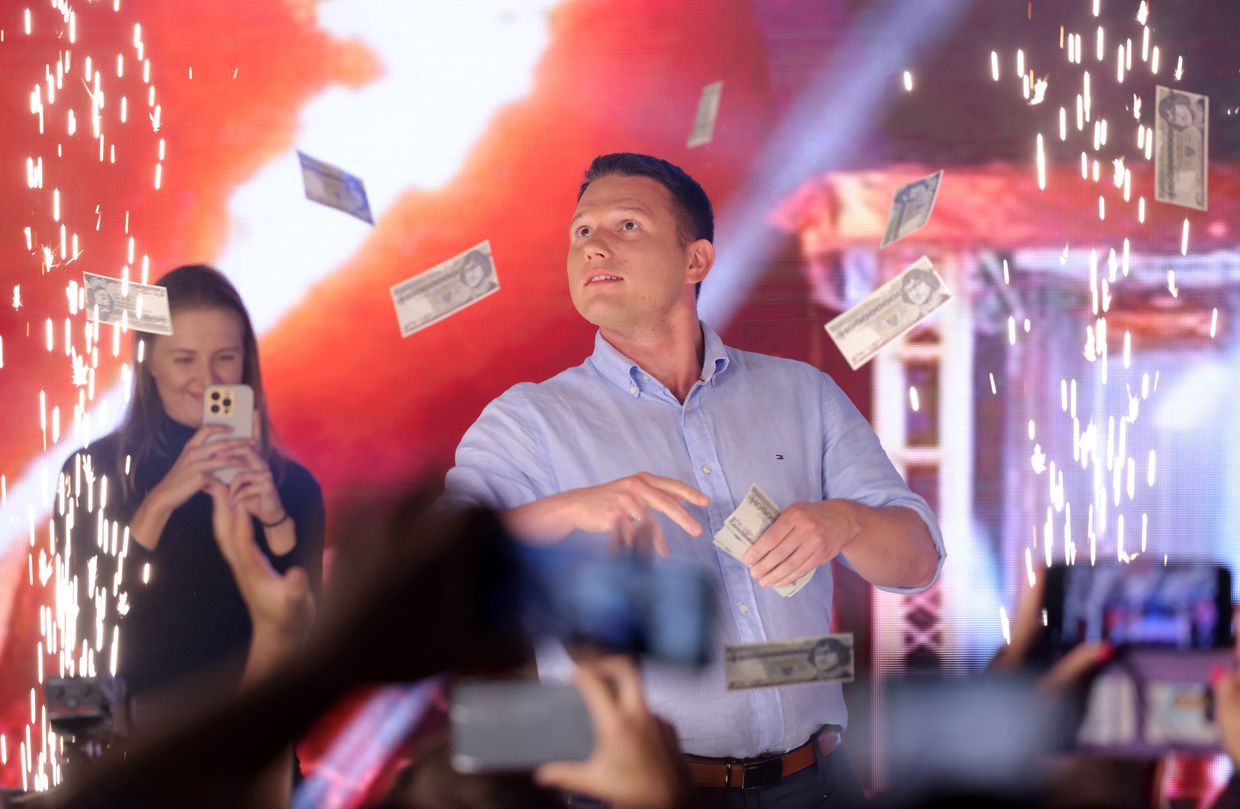 Slawomir Mentzen, co-leader of the Konfederacja alliance, tosses fake money to supporters during a campaign rally in Szczecin, Poland, on Sept. 16, 2023. 