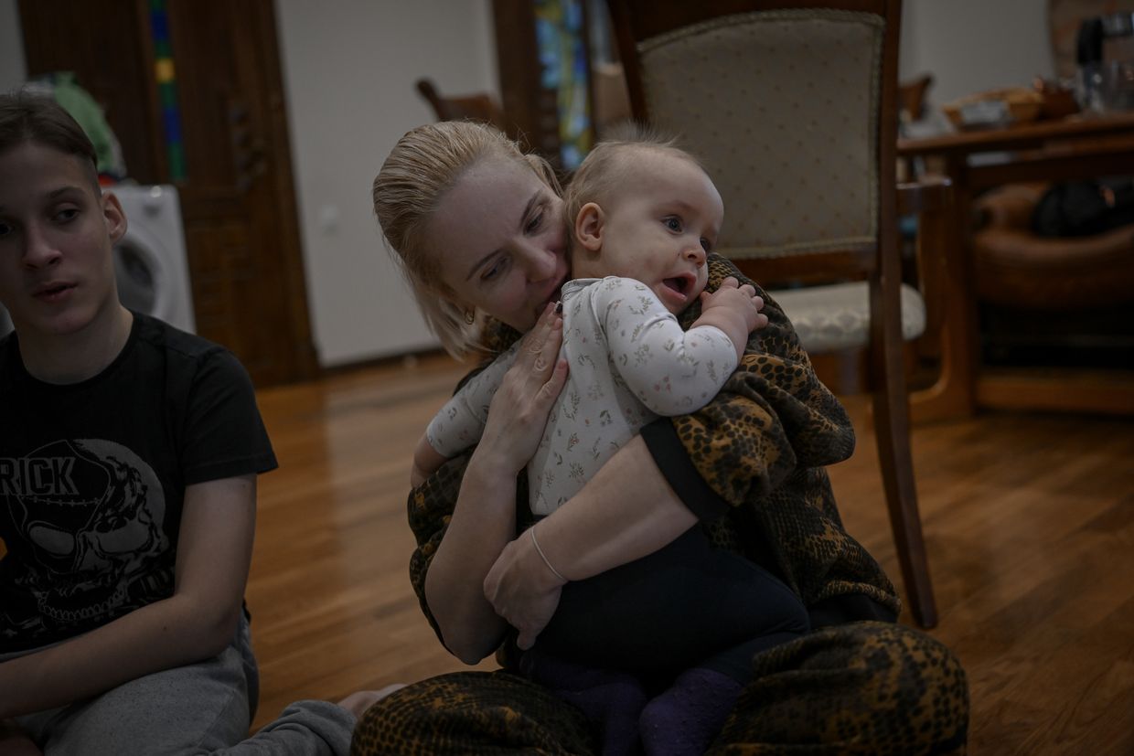 Maria Chupinina hugs 1.5-year-old Alisia, who has Down syndrome, as she fosters sick and disabled children deprived of parental care due to the Russia-Ukraine war in Kharkiv, Ukraine, on Nov. 23, 2023. 