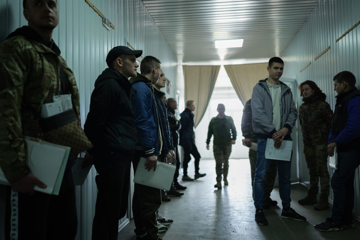 Volunteers gather at a conscription point to join the Ukrainian army in Ukraine on March 26, 2024. 