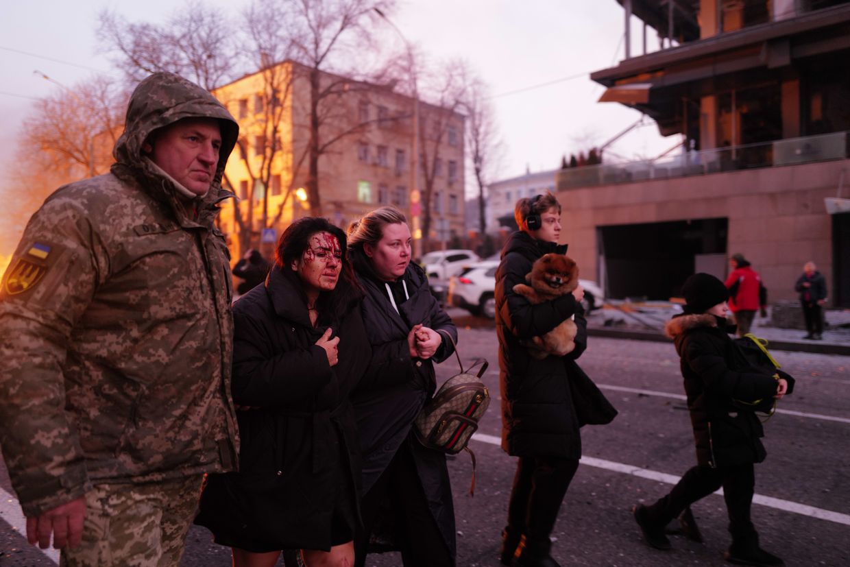 People receive help after missile debris, preliminarily identified as Kinzhal, fell in the Holosiivskyi district of Kyiv, Ukraine, on Dec. 20, 2024.