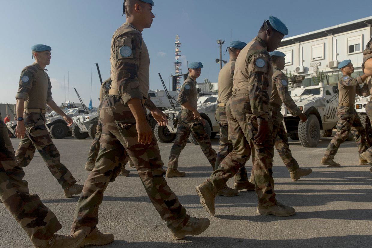 French and Finnish UNIFIL soldiers walk in formation at the Deir Kifa base in South Lebanon on July 25, 2024. 