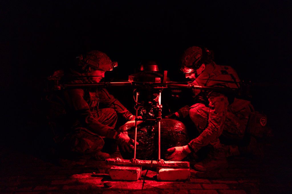 Ukrainian military personnel load a drone with food and ammunition in Kharkiv Oblast on March 7, 2025.