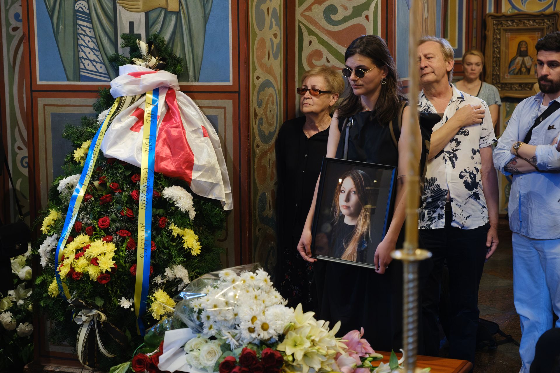 A woman in mourning holds a portrait of the late Victoria Amelina during a funeral ceremony at St. Michael’s Golden-Domed Monastery in Kyiv, Ukraine, on July 4, 2023.