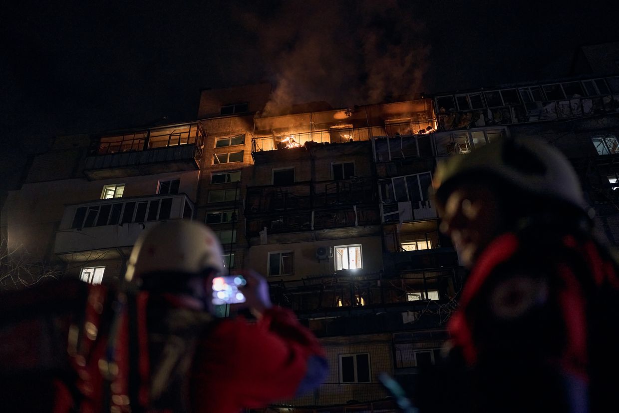 Emergency personnel respond after a Shahed drone attack set fire to a multi-story residential building in Lviv, Ukraine, on March 23, 2025. 