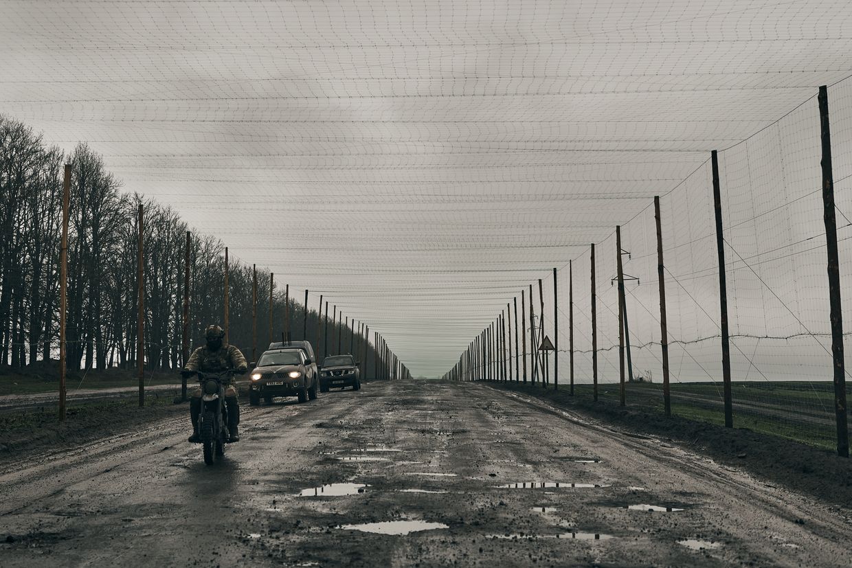 The road to the border with Russia is covered with a net to protect against FPV kamikaze drones in Sumy Oblast, Ukraine, on April 4, 2025.