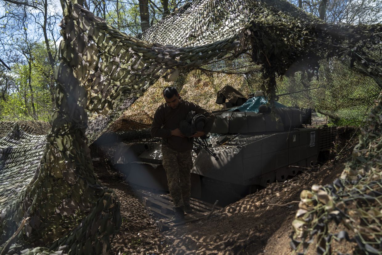 Ukrainian tank crew members service a captured T-80 tank following battles with Russian forces in Kostiantynivka District, Donetsk Oblast, Ukraine, on April 27, 2025.