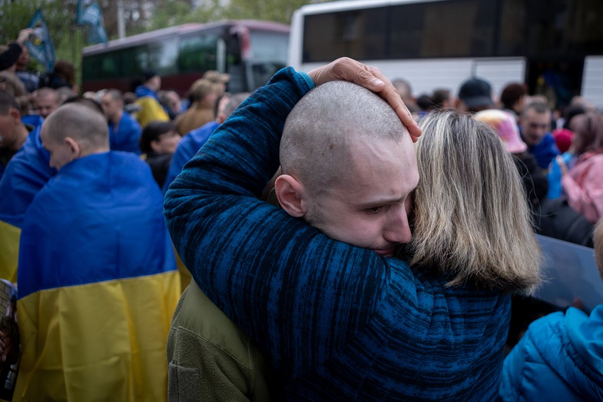 Relatives embrace a Ukrainian soldier released from Russian captivity during a prisoner exchange in Ukraine on May 6, 2025.