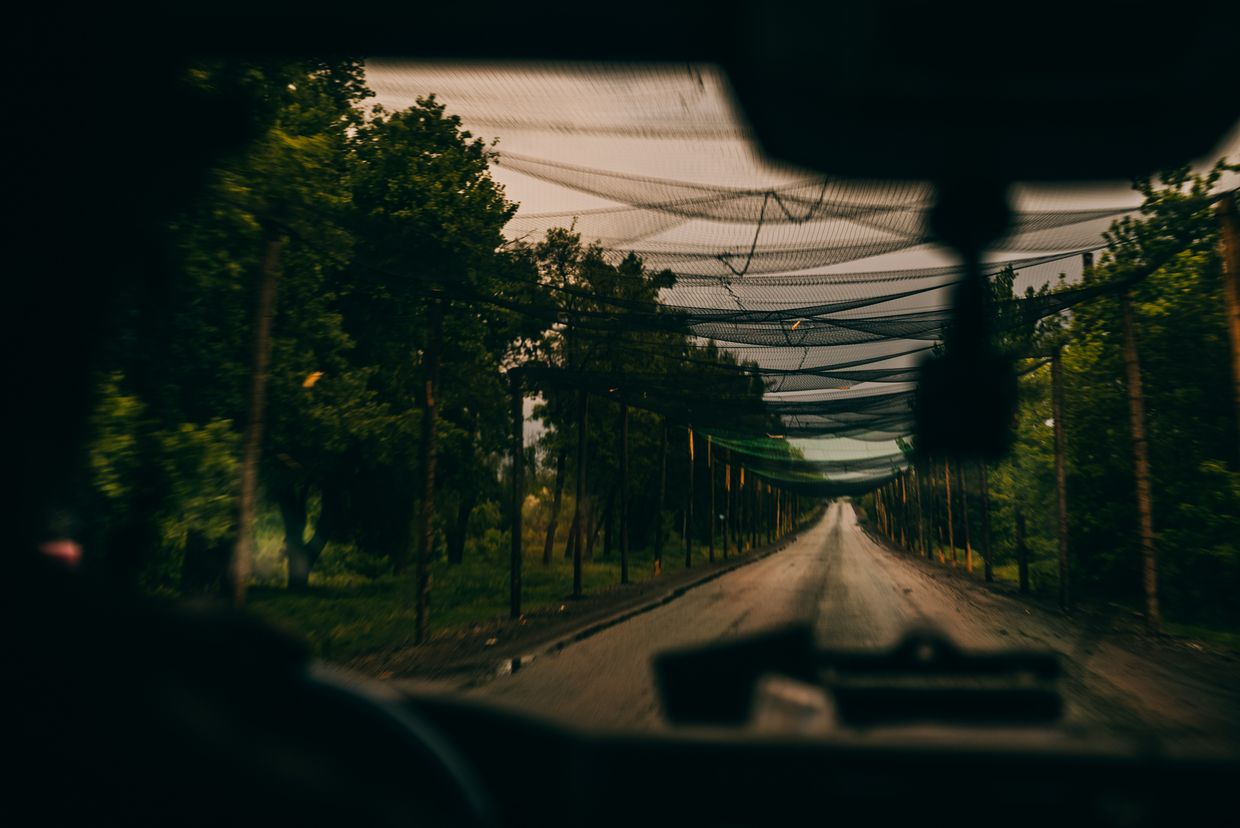 Police crew members of the “White Angels” drive through the road covered by FPV drones