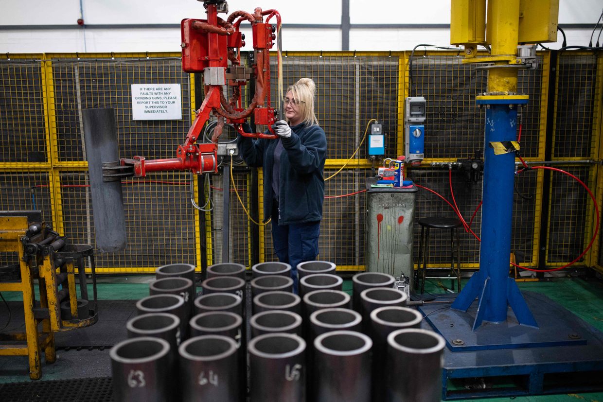 An employee maneuvers 155mm artillery shell casings during manufacturing at the BAE Systems factory in Washington, United Kingdom, on Nov. 8, 2023.