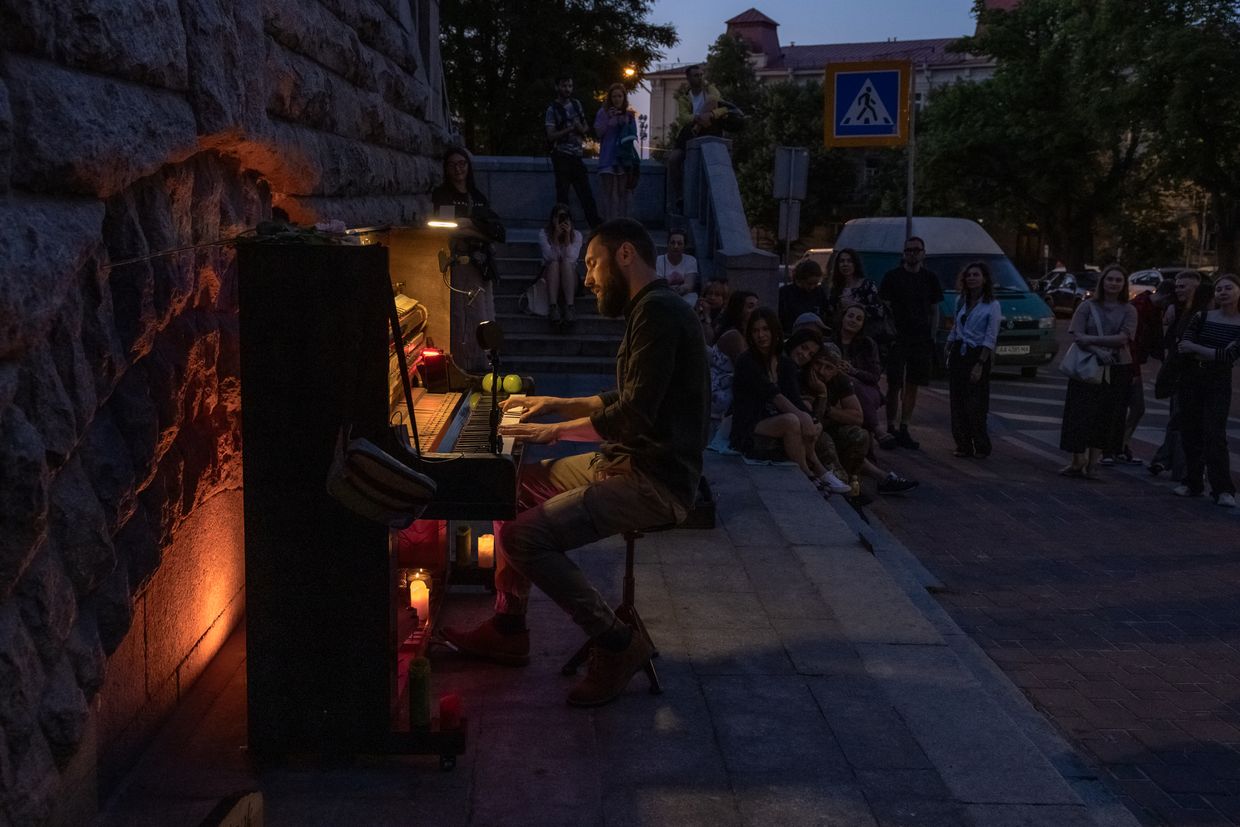 A street musician plays the piano during a partial blackout in Kyiv, Ukraine, on June 6, 2024
