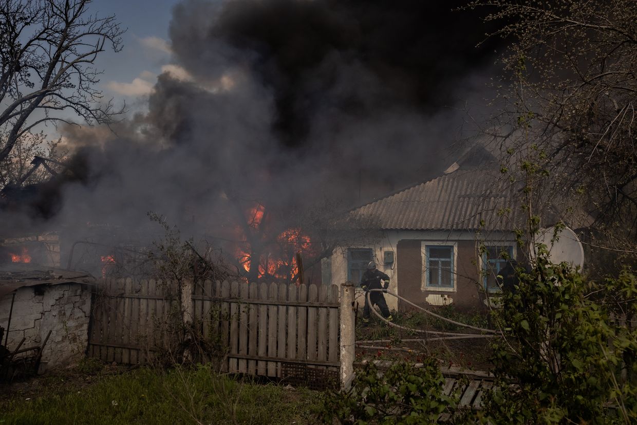 Ukrainian firefighters extinguish a fire in houses after an attack in Chernihivka village, Pokrovsk district, Donetsk Oblast, Ukraine, on April 22, 2025.