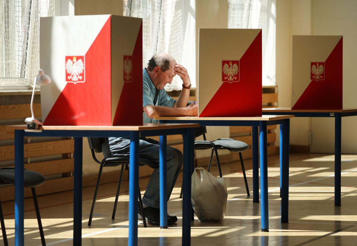 A man fills in his ballot during Poland’s presidential runoff election in Warsaw, Poland, on June 1, 2025. 