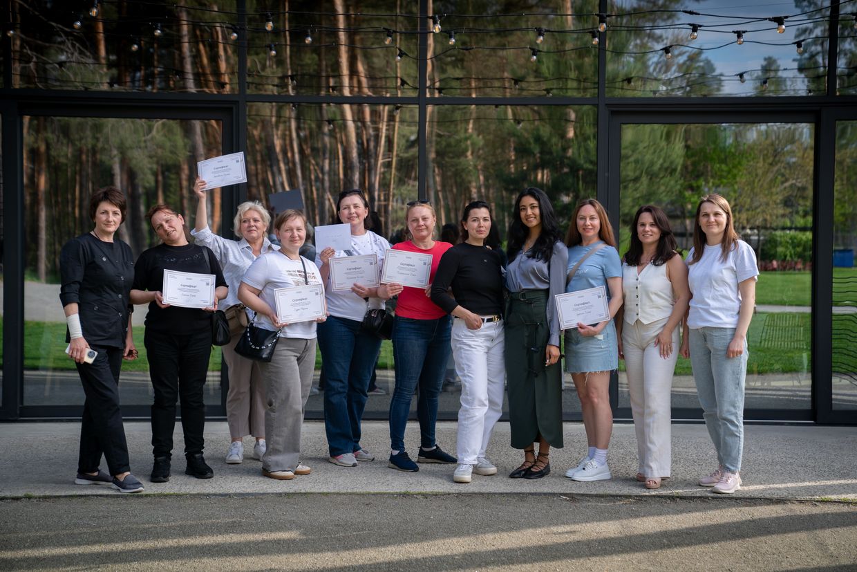 Graduates of the first Grains hospitality school for internally displaced people pose with their certificates at the SHELEST