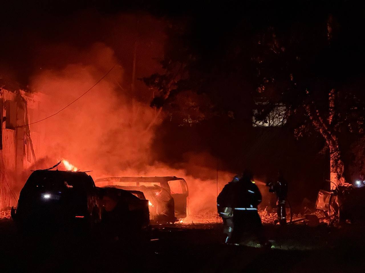 Firefighters extinguish burning cars in an intense fire amid a Russian missile attack on June 7, 2025.