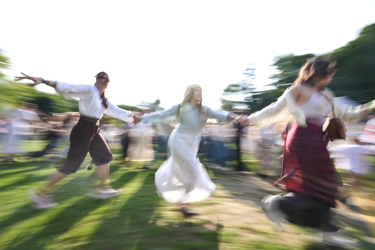 People wearing traditional embroidered “vyshyvankas” dance during ChekaFest in Lviv, Ukraine, on June 1, 2025.