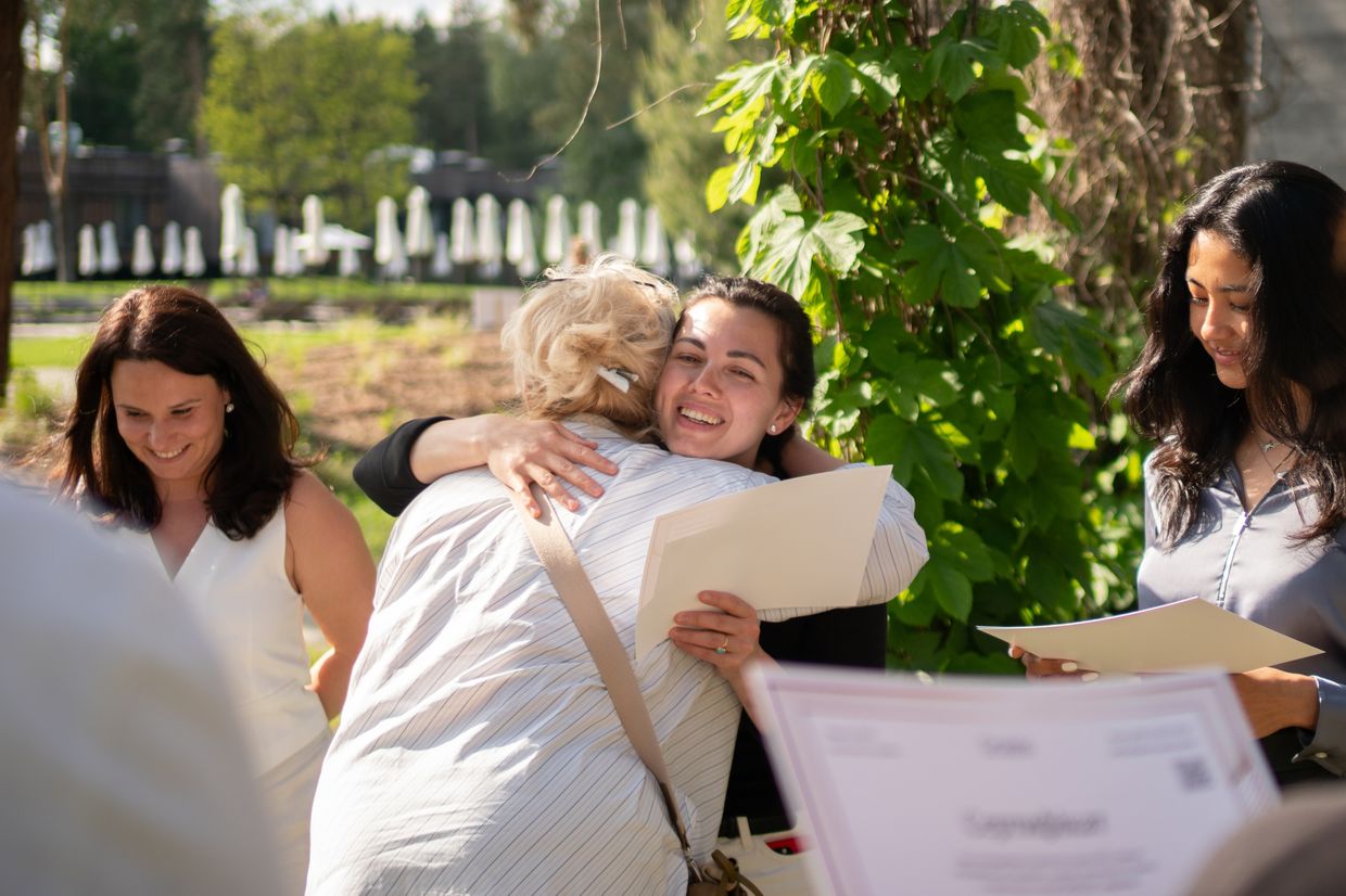 A student hugs a teacher during the graduation ceremony of the first Grains hospitality course for IDPs
