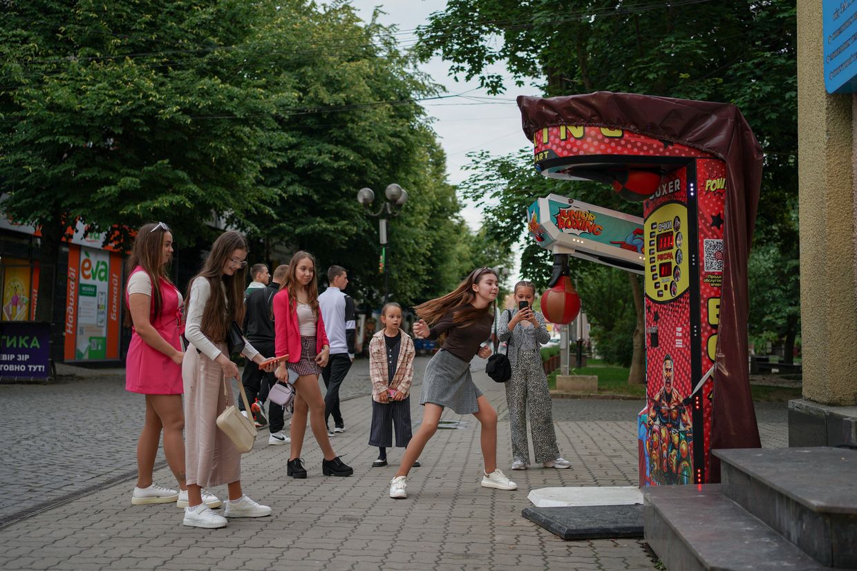 Girls playing boxing punch game on the street in Berehove, Zakarpattia Oblast, Ukraine on May 22, 2025. 