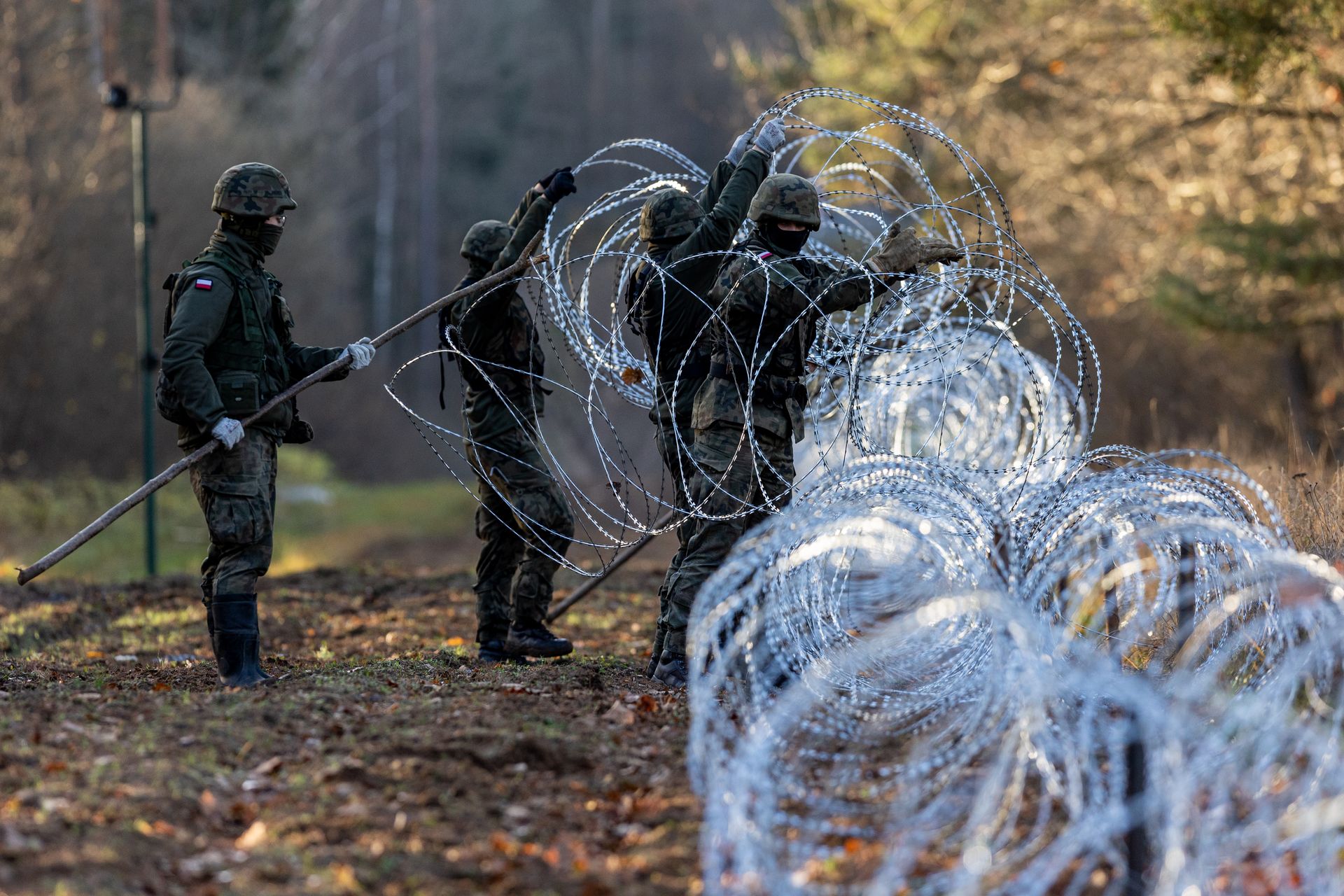 Polish soldiers install concertina wire at the border with Kaliningrad.