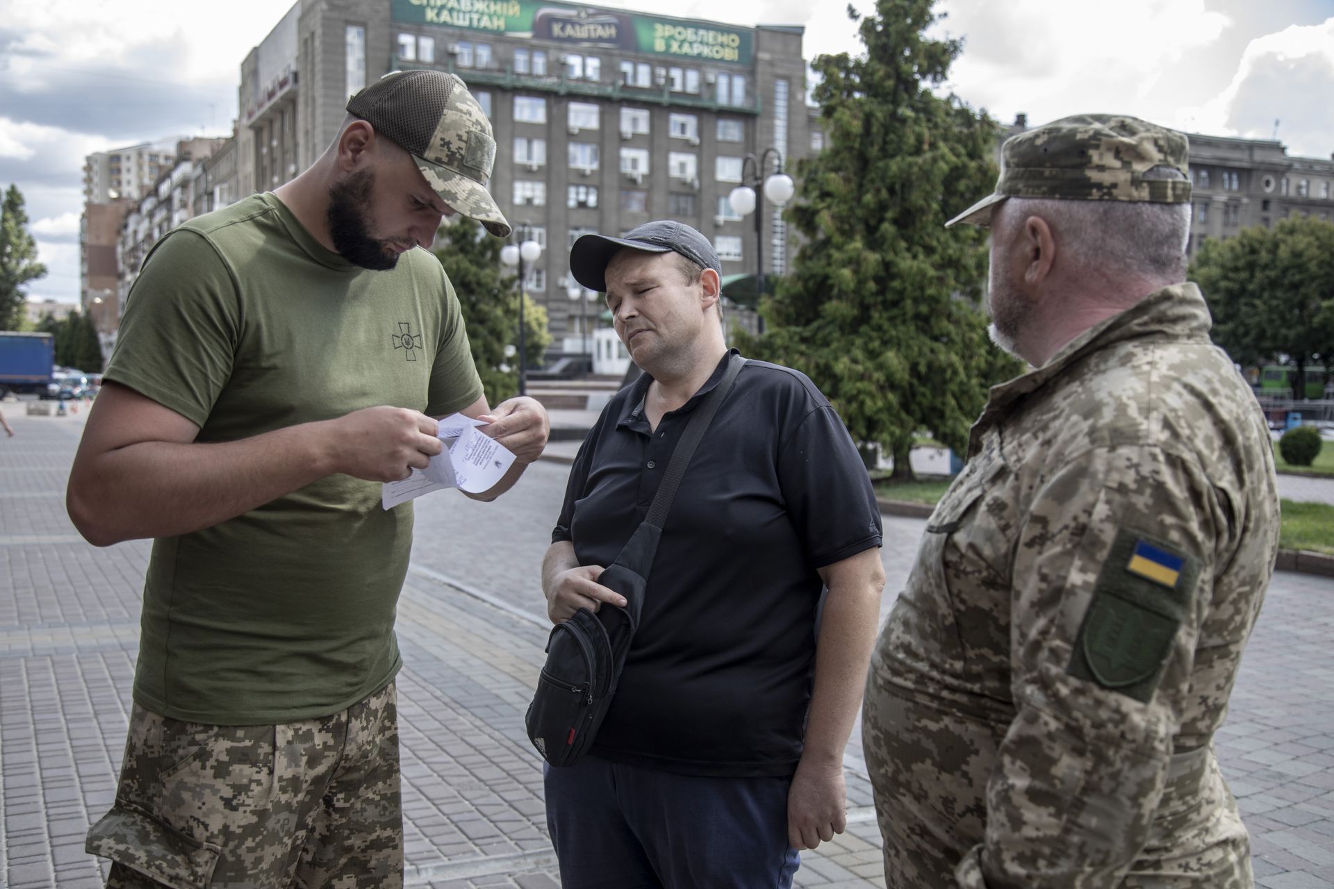 Kharkiv Regional Recruitment Office (TCC) check a civilian’s documents while patrolling a key location to find men of fighting age to bring them to the recruiting office in Kharkiv,  Ukraine, on Aug. 8, 2024. 