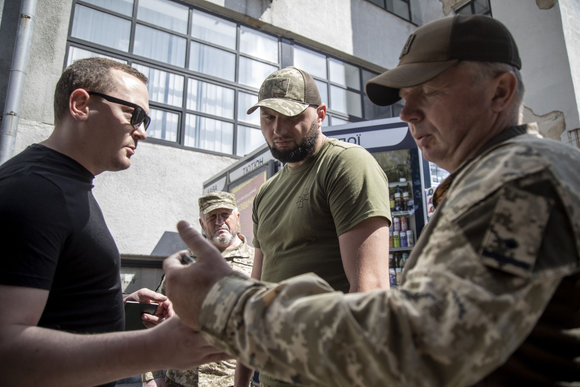 Recruiters check documents of men eligible for conscription in Kharkiv, Ukraine, on Aug. 8, 2024.
