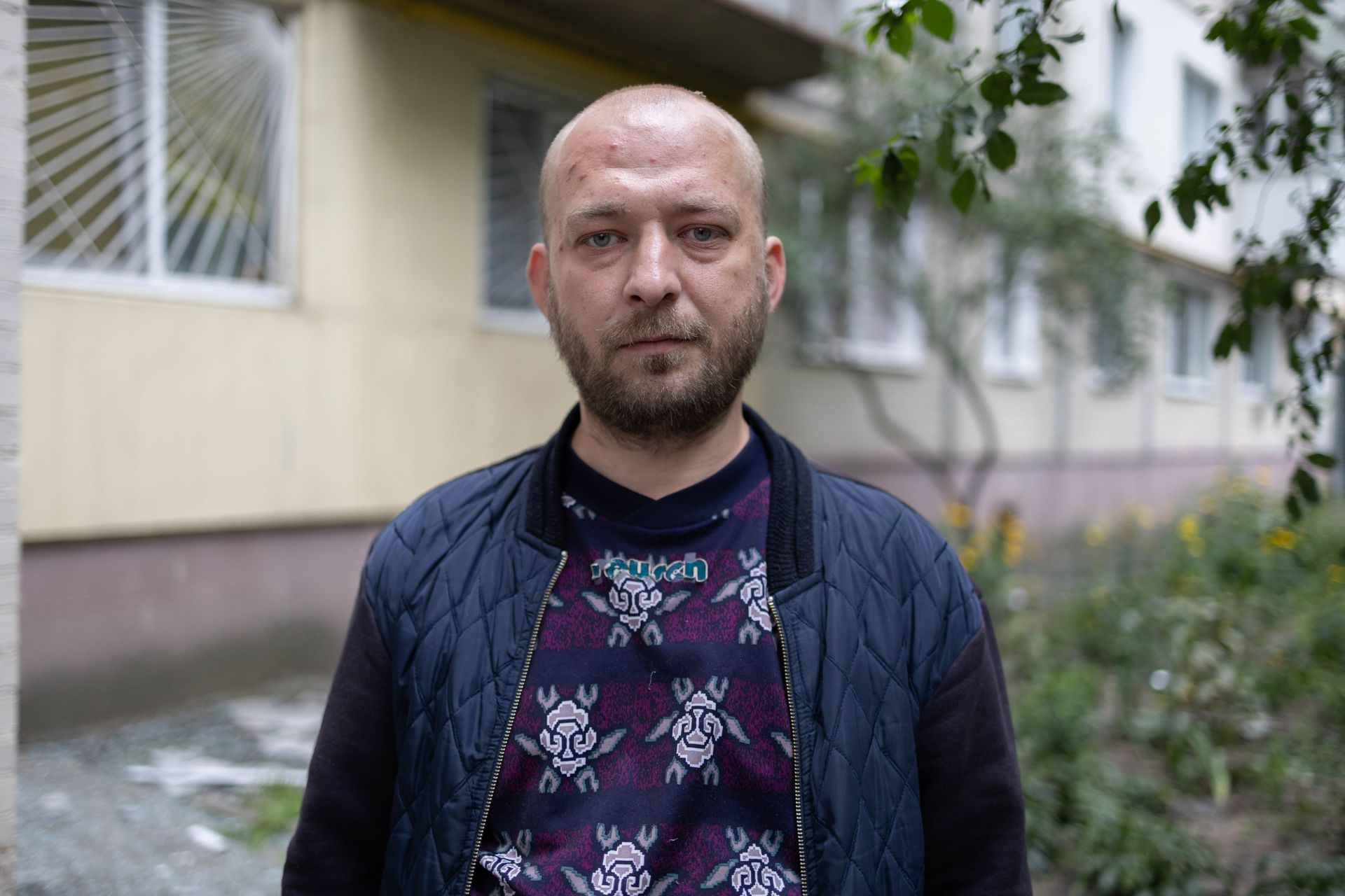 Anton Melnychonok, who was formerly in the army, near the house he lives in that was damaged due to Russian overnight attack in Kyiv, Ukraine on July 31, 2025. 