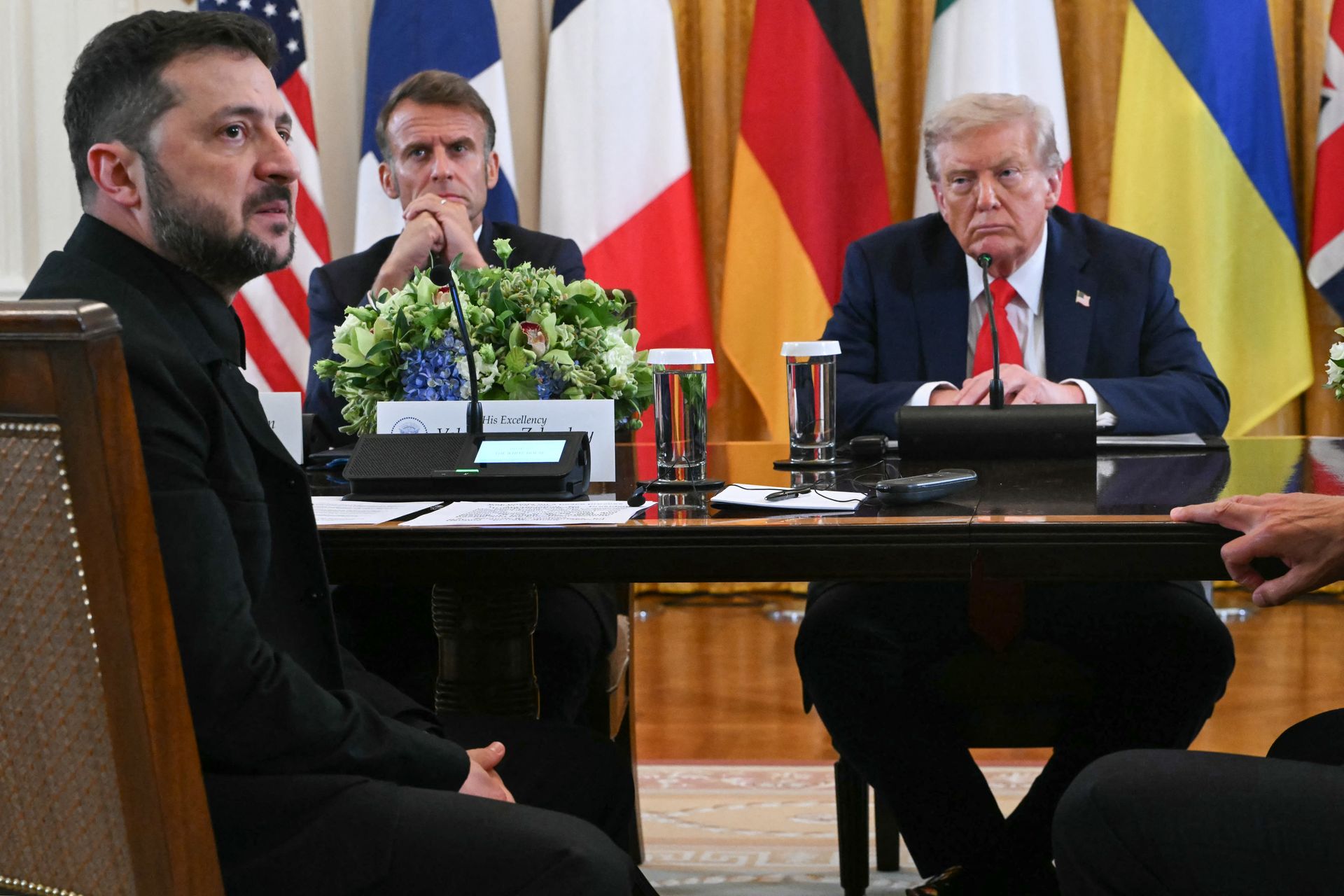 French President Emmanuel Macron (C) and U.S. President Donald Trump (R) listen as President Volodymyr Zelensky (L) speaks during a meeting with European leaders in Washington, D.C., U.S. on Aug. 18, 2025. 