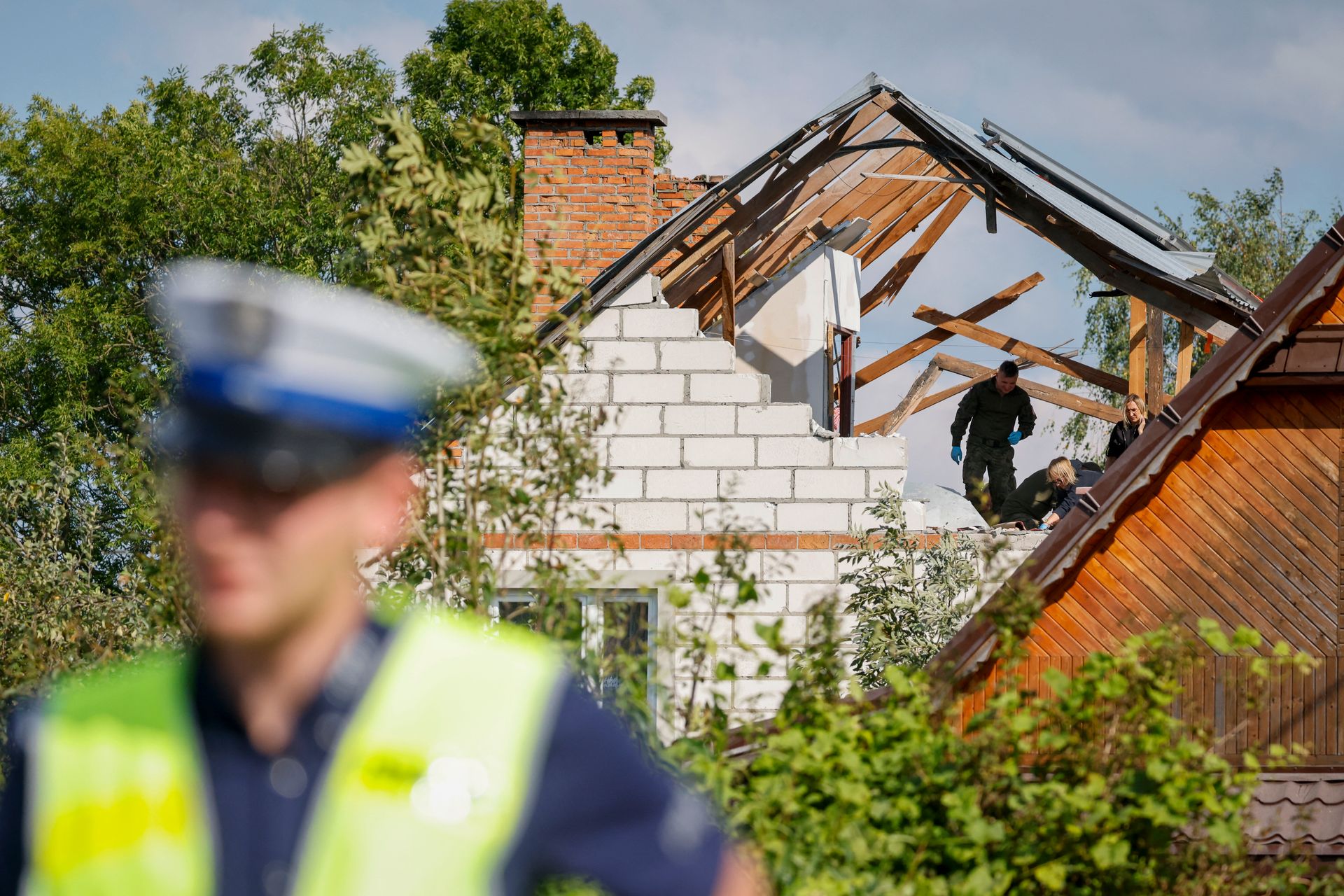 Police and army inspect damage at the house, destroyed by debris from a shot-down Russian drone, in the village of Wyryki-Wola, Poland, on Sept. 10, 2025.