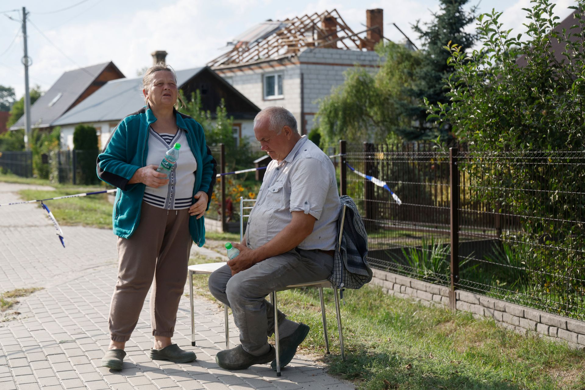 Alicja Wesolowska (L) and her husband Tomasz Wesolowski (R) stand in front of their house damaged by debris from a Russian drone shot down in Wyryki-Wola, Poland, on Sept. 10, 2025.