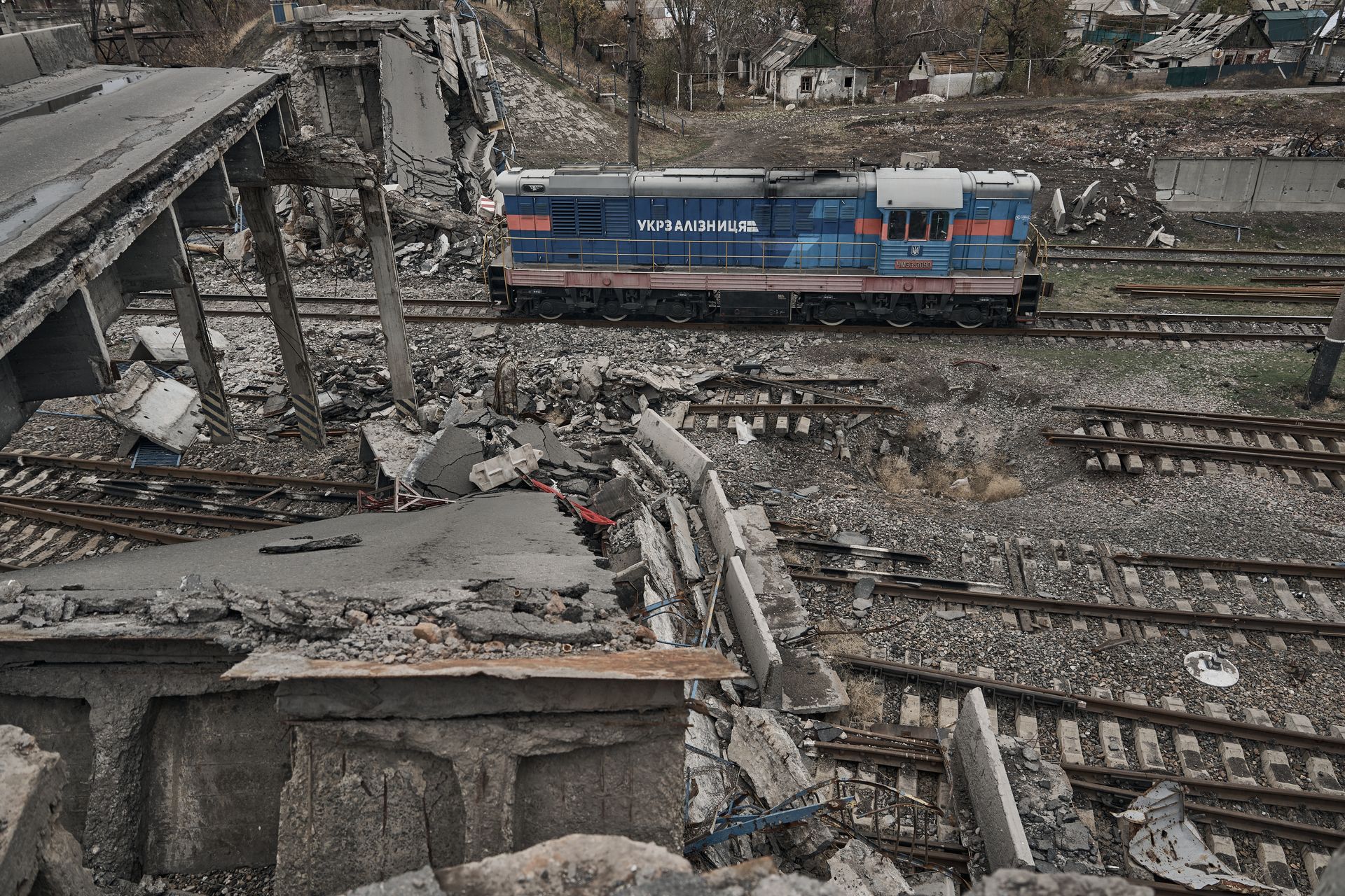A locomotive passes under a destroyed bridge on a heavily damaged railway track in Pokrovsk, Donetsk Oblast, Ukraine, on Nov. 16, 2024.