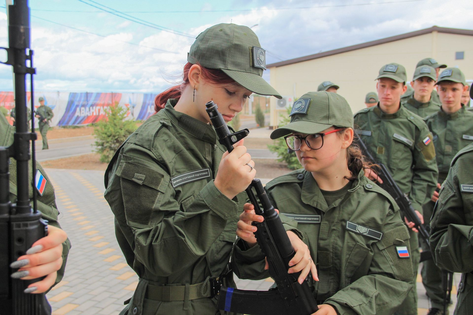 Girls handle rifles during a weapons assembly at the “Time of Young Heroes” program in an Avangard defense and sports camp in Volgograd Region, Russia, in a photo published June 21, 2024.