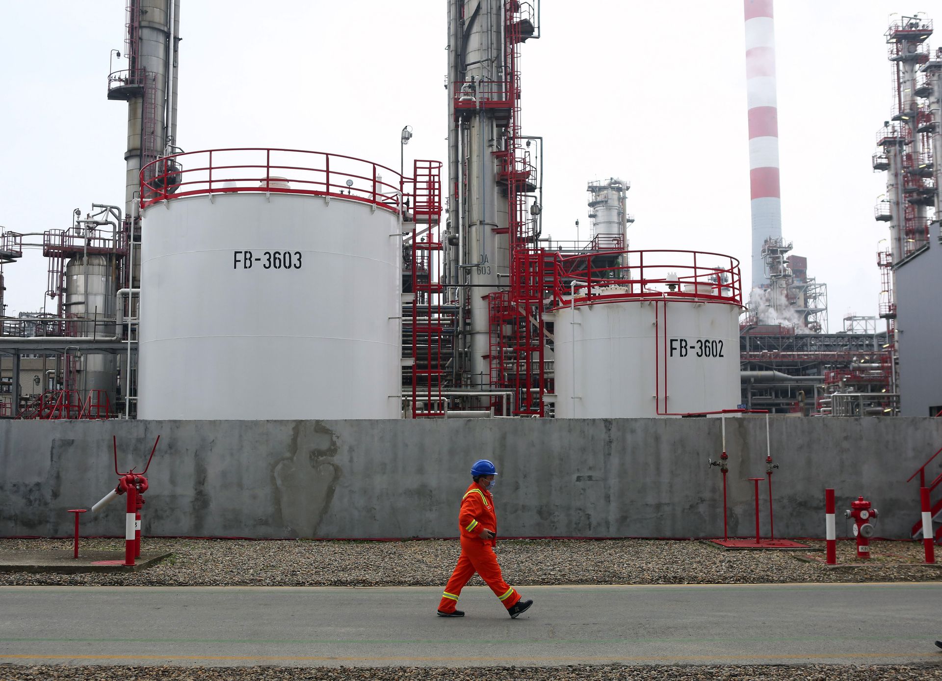 A worker walks through the grounds of the Naftna Industrija Srbija AD (NIS) deep oil processing and refining complex, operated by Gazprom PJSC, in Pancevo, Serbia, on Nov. 18, 2020. 