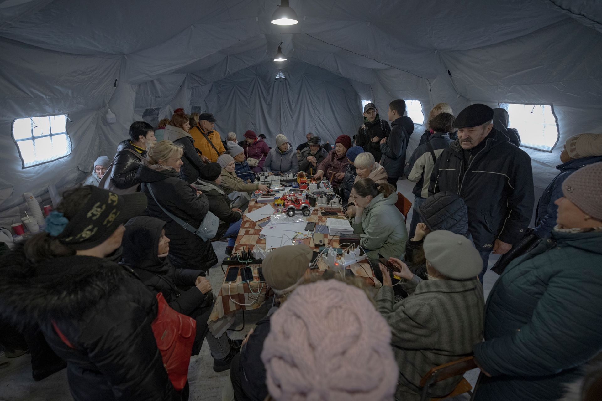Chernihiv residents charge their electronic devices at a Point of Invincibility during a blackout in Chernihiv, Ukraine, on Oct. 10, 2025.