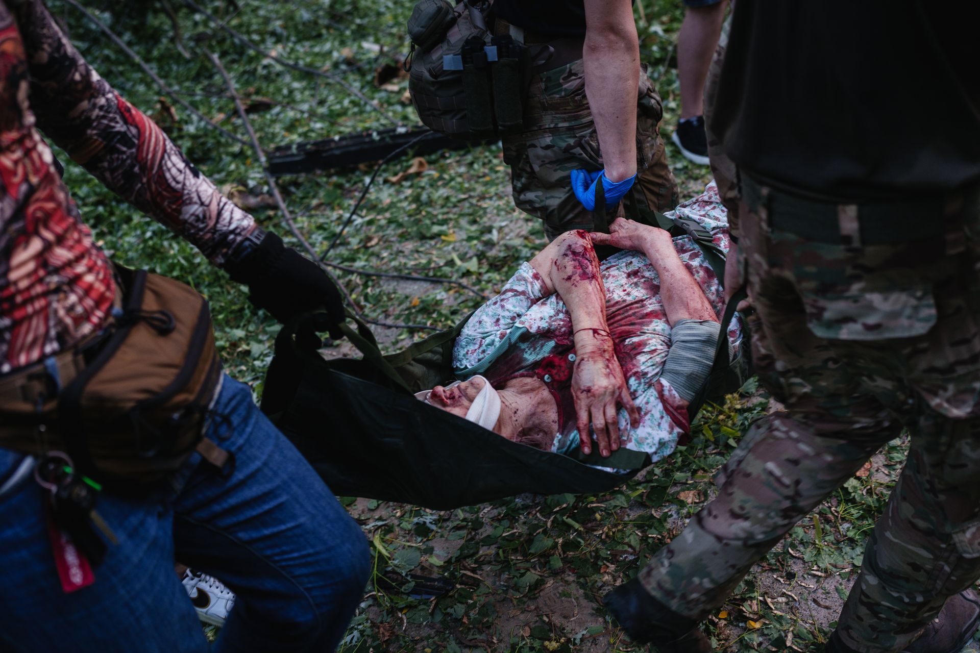 Medics carry a wounded woman on a stretcher following a combined Russian drone and missile strike on Kyiv, Ukraine, which killed at least 14 people and damaged residential buildings, a kindergarten, and civilian infrastructure across multiple districts of the capital.