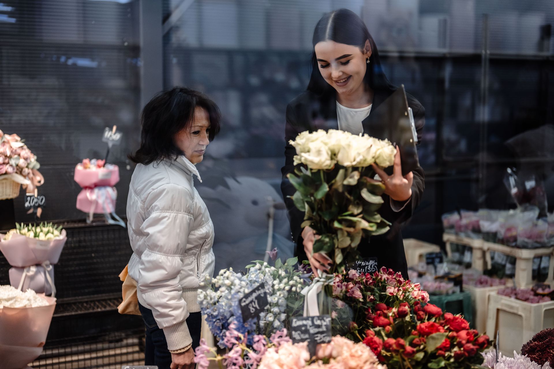 Olena Holovach, a customer at the Flora de Luxe flower shop in Kyiv, Ukraine, picks out flowers for her sister’s birthday on Nov. 7, 2024.