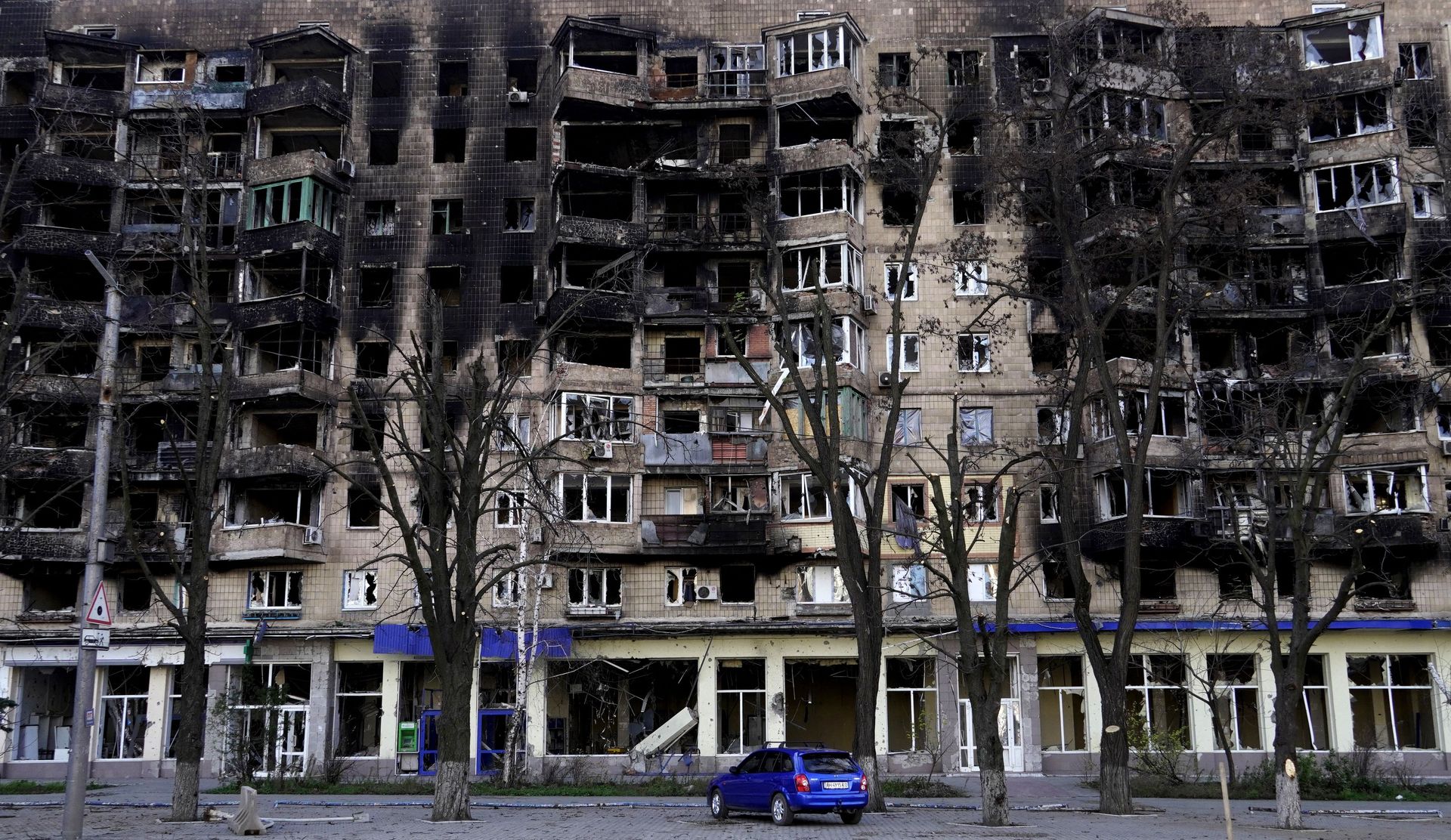 A car stands in front of a damaged building in the Russian-occupied port city of Mariupol, Ukraine, on Nov. 29, 2022.