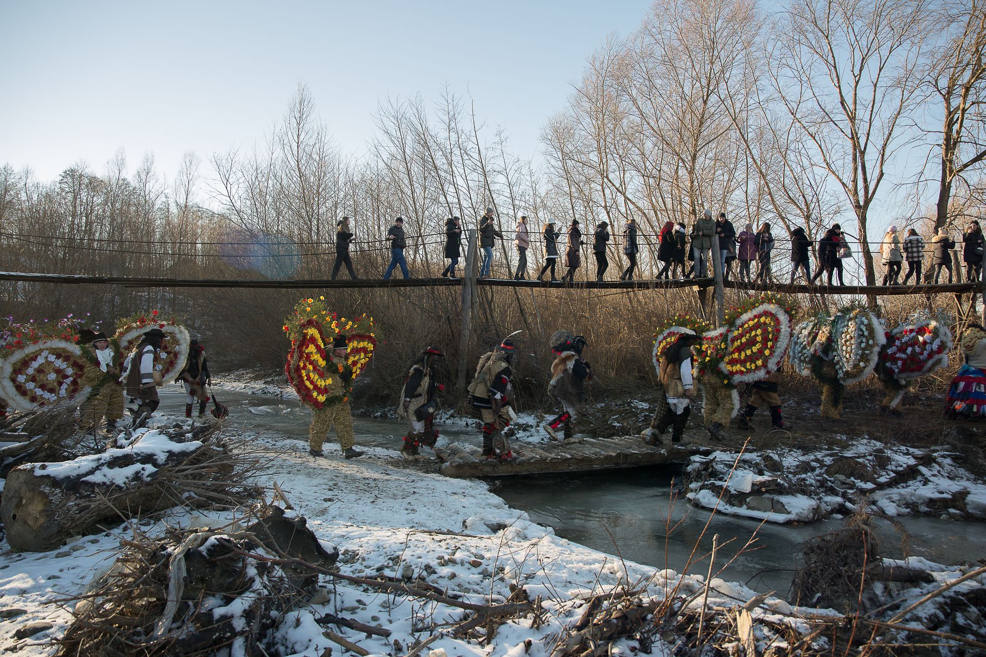 A procession crosses a bridge during Malanka celebrations in Krasnoilsk, Chernivtsi Oblast, Ukraine, on Jan. 14, 2022.