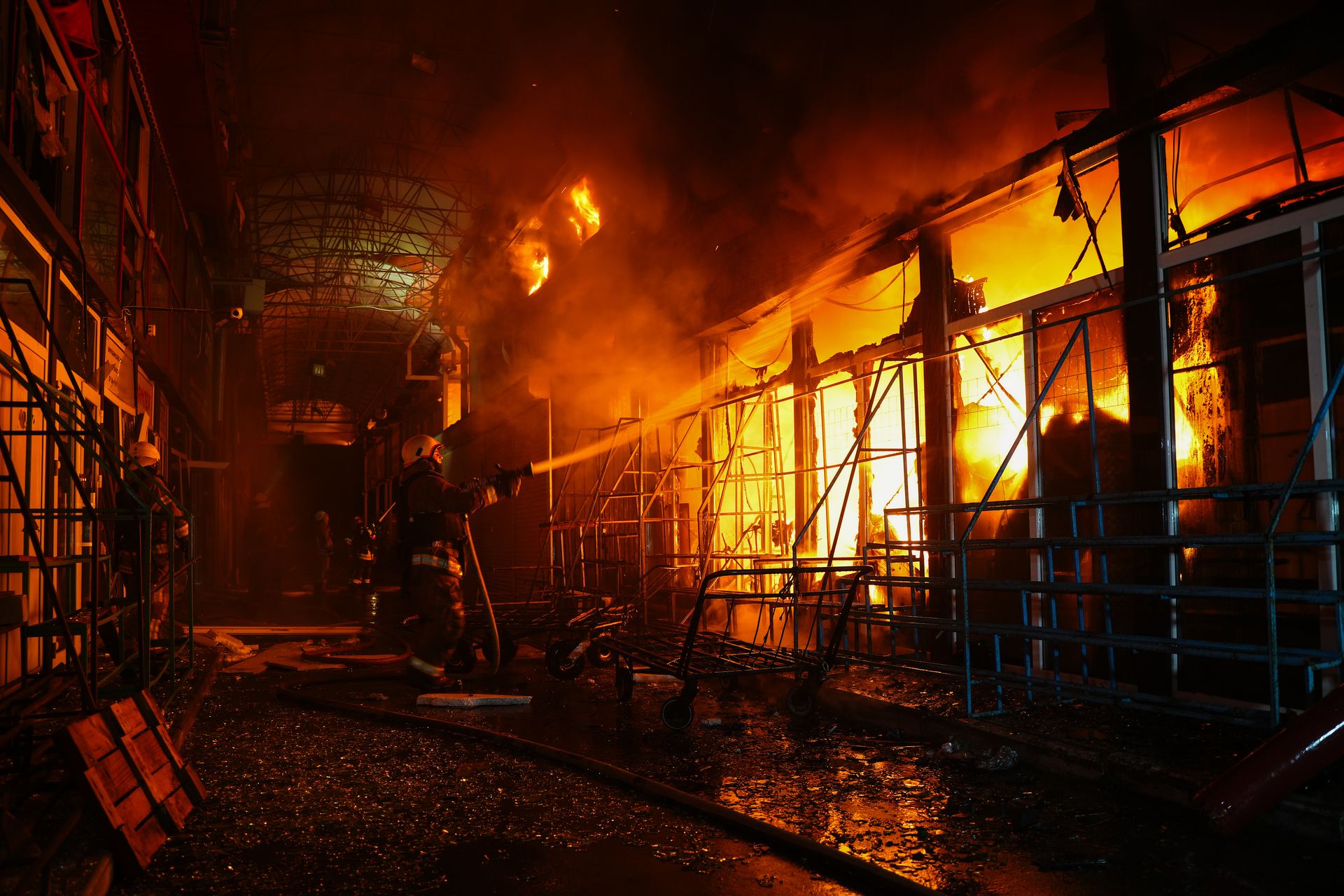 Firefighters extinguish a fire at Barabashovo market following a Russian aerial attack in Kharkiv, Ukraine, on Oct. 1, 2025. 