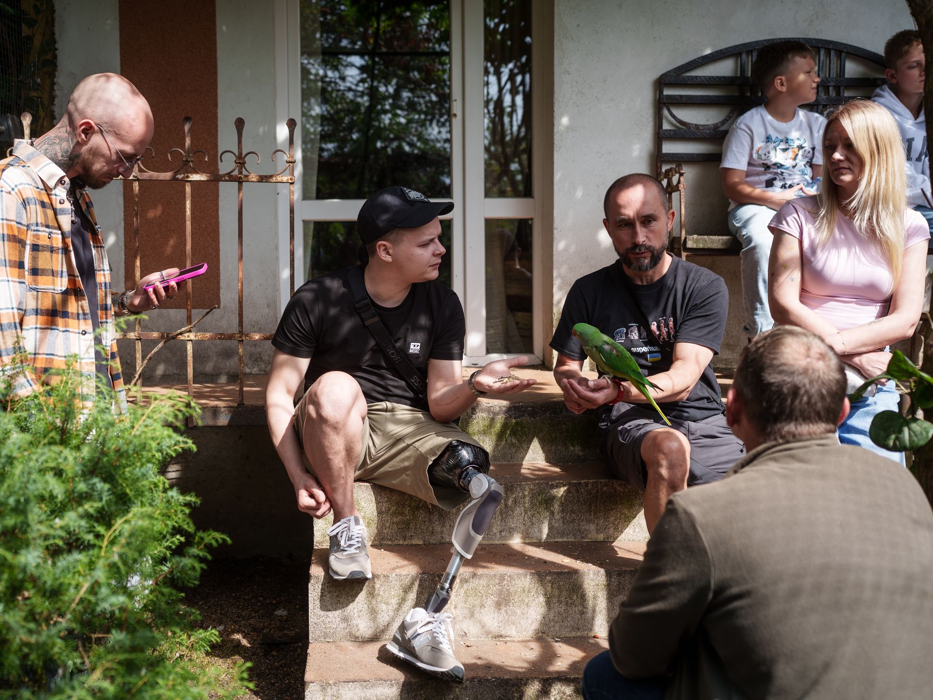 Veterans from the Superhumans rehabilitation center in Lviv visit the Free Wings rehabilitation center in Kozhychi, Lviv Oblast, Ukraine, on Aug. 27, 2025, where they interact with birds as part of their recovery process.
