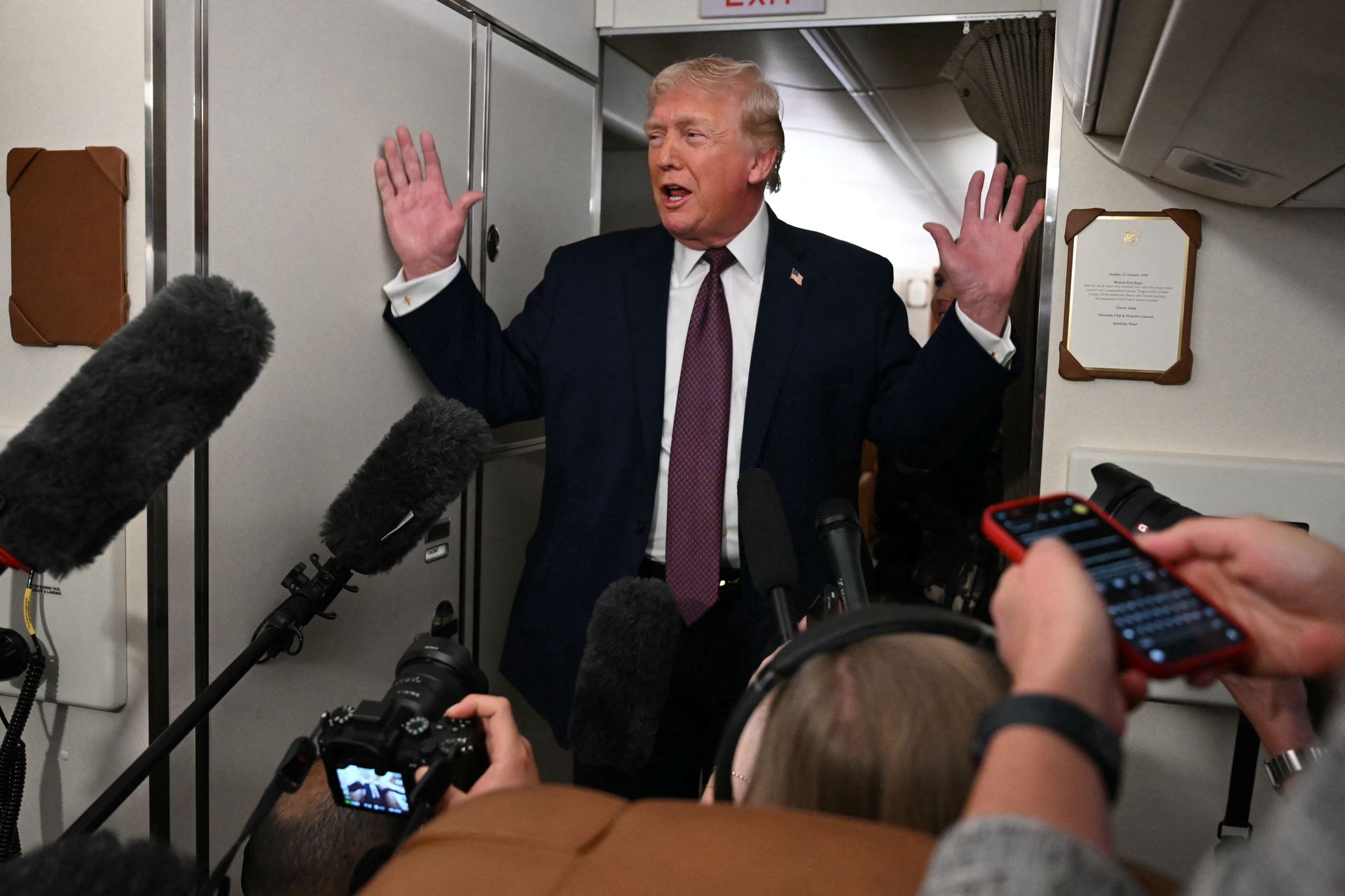U.S. President Donald Trump speaks to the press aboard Air Force One on Jan. 11, 2026.