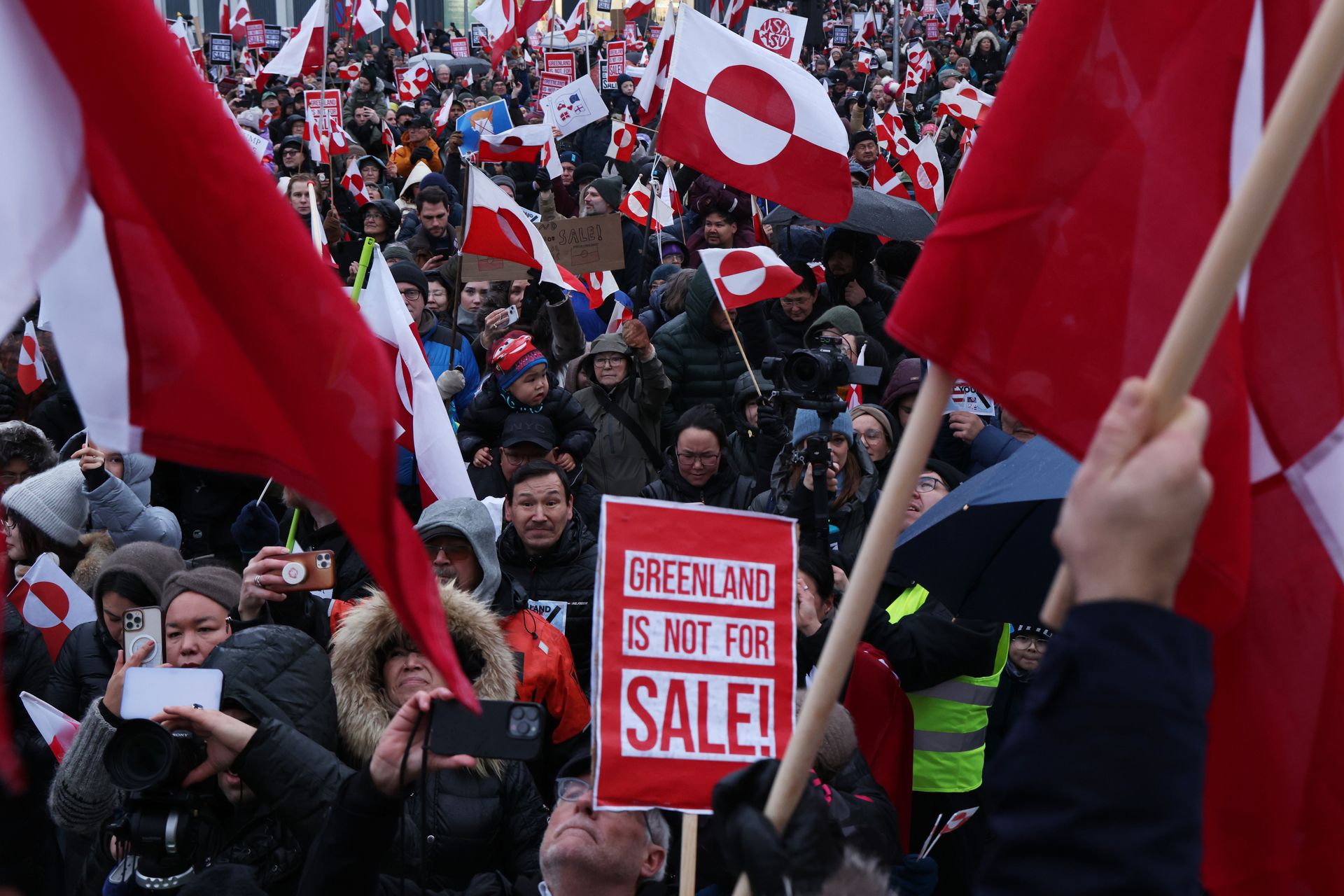 People hold Greenlandic flags and placards as they march in protest against U.S. President Donald Trump and his stated intent to acquire Greenland in Nuuk, Greenland, on Jan. 17, 2026. 