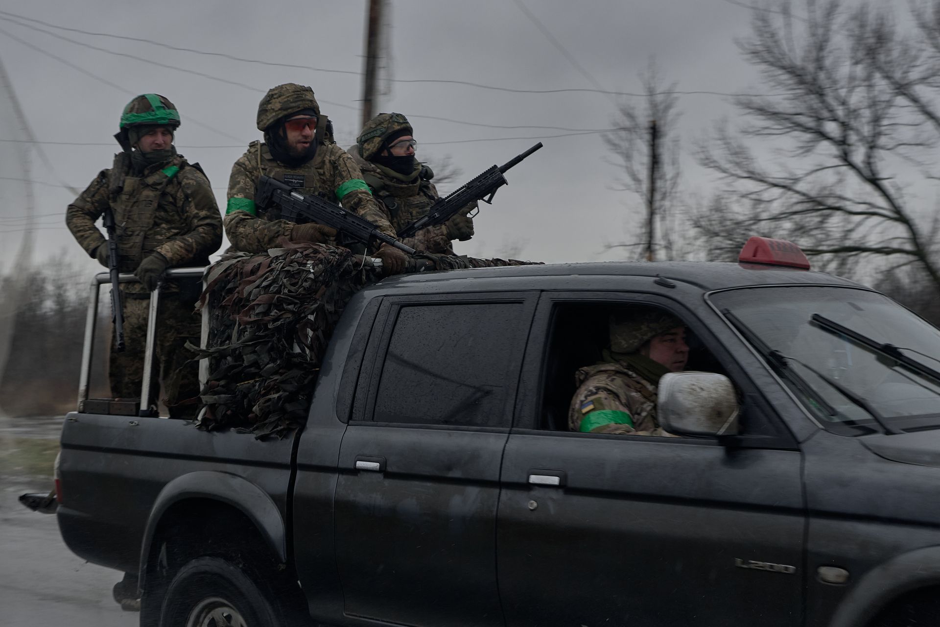 Servicemen drive along a road near the front line in Donetsk Oblast, Ukraine, on Feb. 13, 2026.
