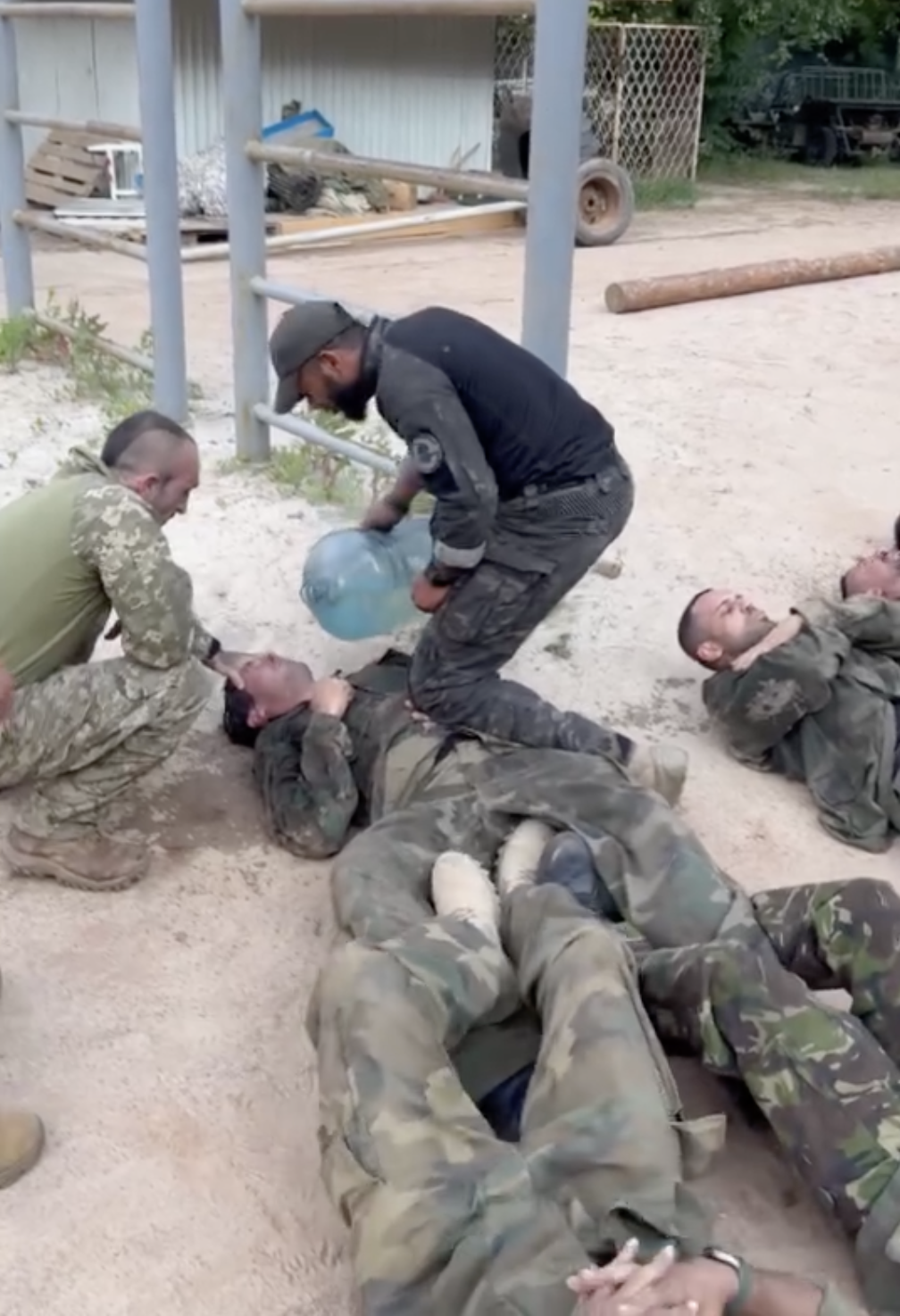 A screen grab from a video shows the alleged hazing of a member of a Brazilian-led unit of the Ukrainian Armed Forces.