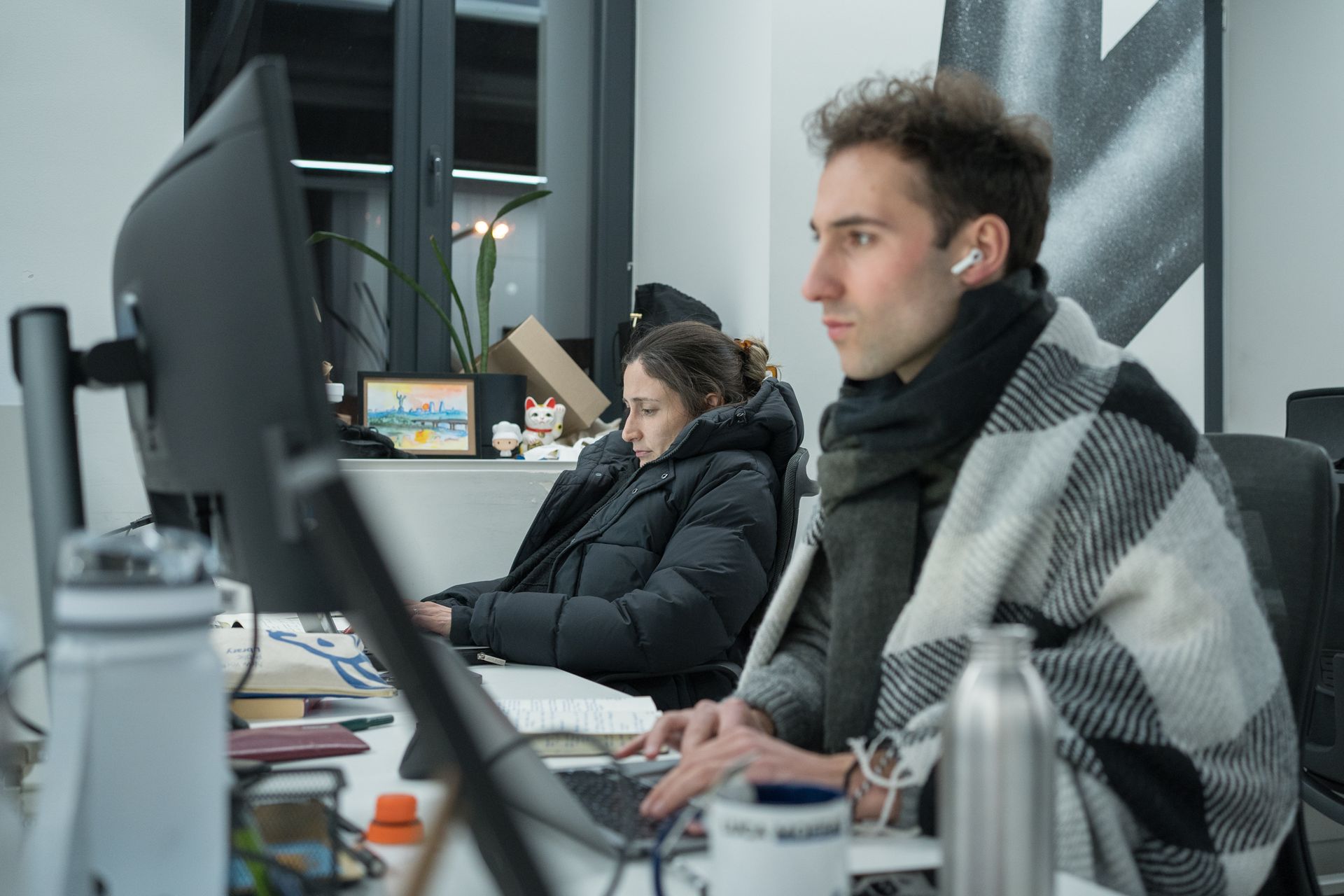 Lili Bivings (L) and Luca Léry Moffat (R) of The Kyiv Independent’s business desk work in the newsroom in Kyiv, Ukraine, on Jan. 14, 2026.