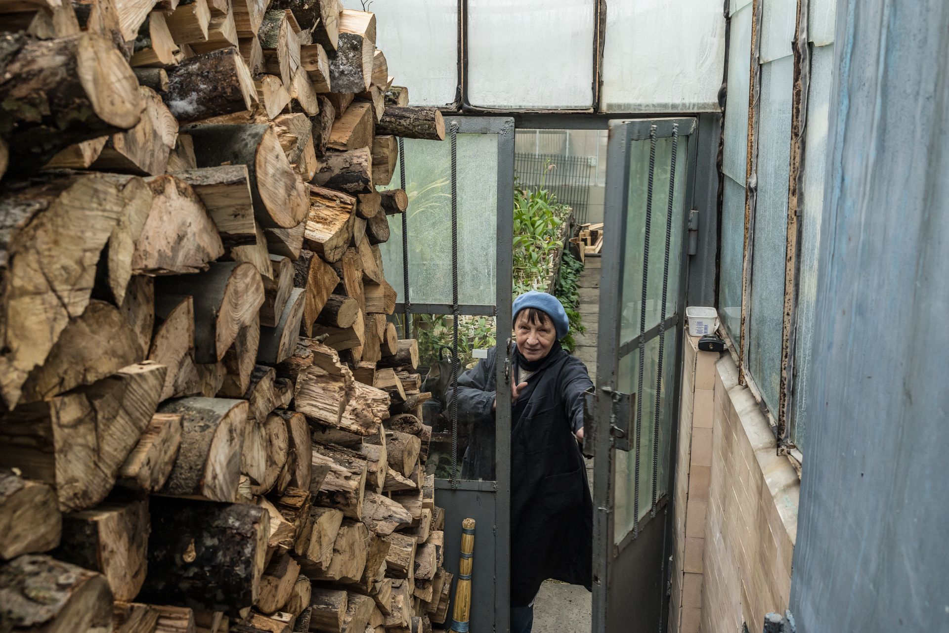 An employee closes a door to keep cold air out of a greenhouse housing collectible plants at the Kyiv National Botanical Garden in Kyiv, Ukraine, on Jan. 30, 2026.