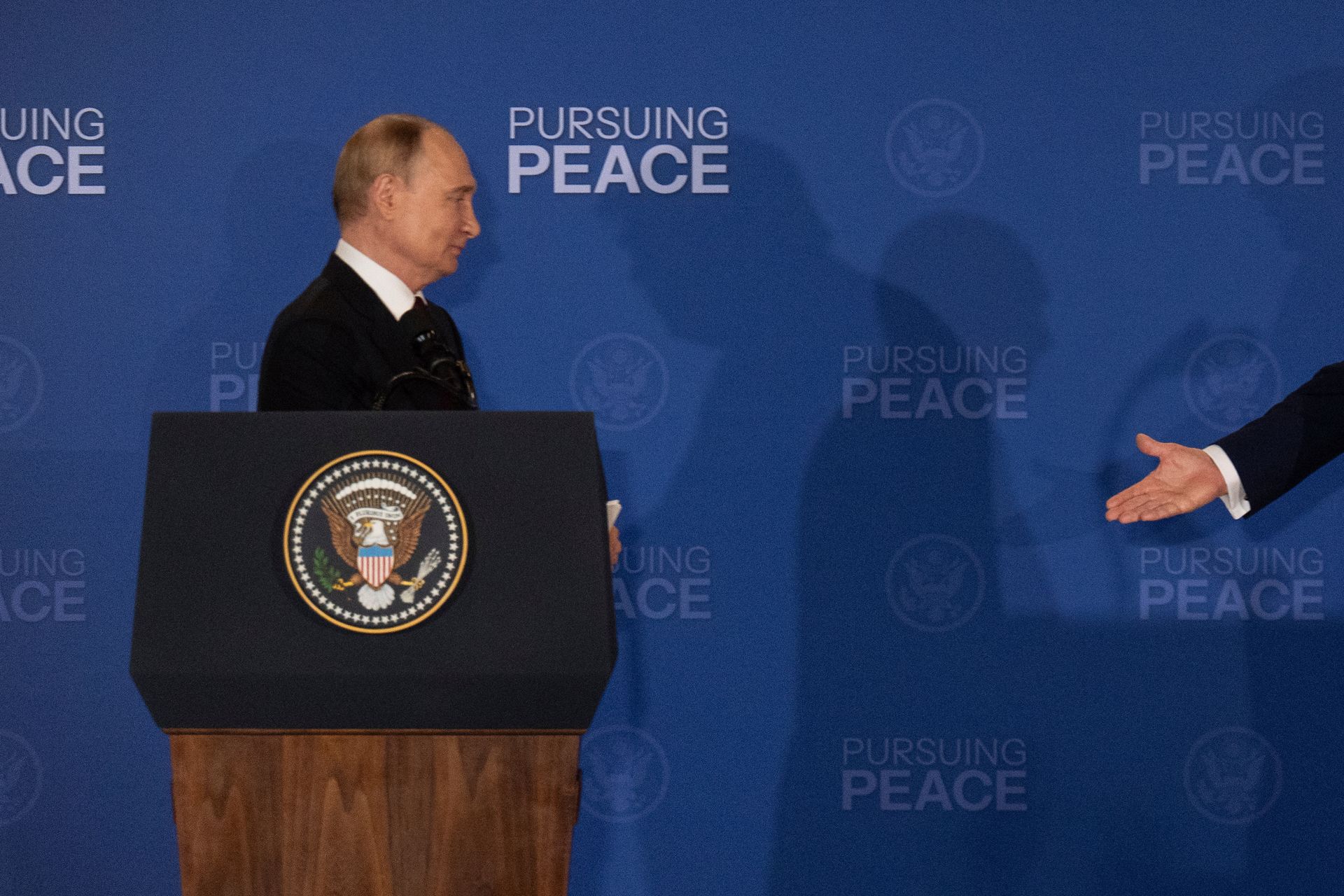 President Donald Trump (R) walks toward Russian President Vladimir Putin (L) to shake hands during a joint press conference at Joint Base Elmendorf-Richardson in Anchorage, Alaska, U.S. on Aug. 15, 2025. 
